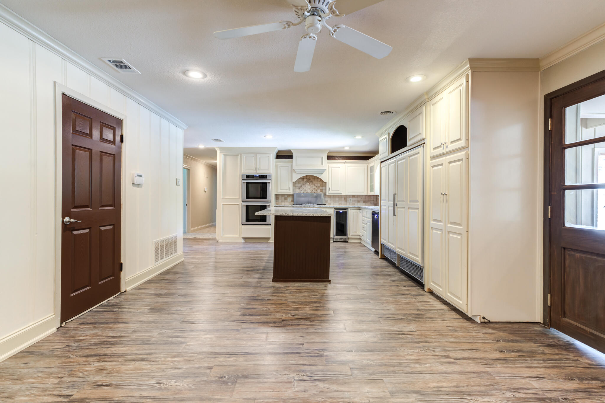 3511 44th Street Lubbock, TX 79413 - Photo 12 of 24 a room with stainless steel appliances kitchen island granite countertop a refrigerator and a stove top oven