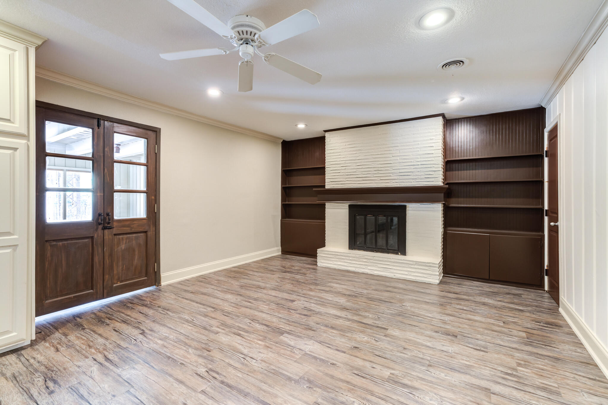 3511 44th Street Lubbock, TX 79413 - Photo 13 of 24 a view of an empty room with a kitchen and a window