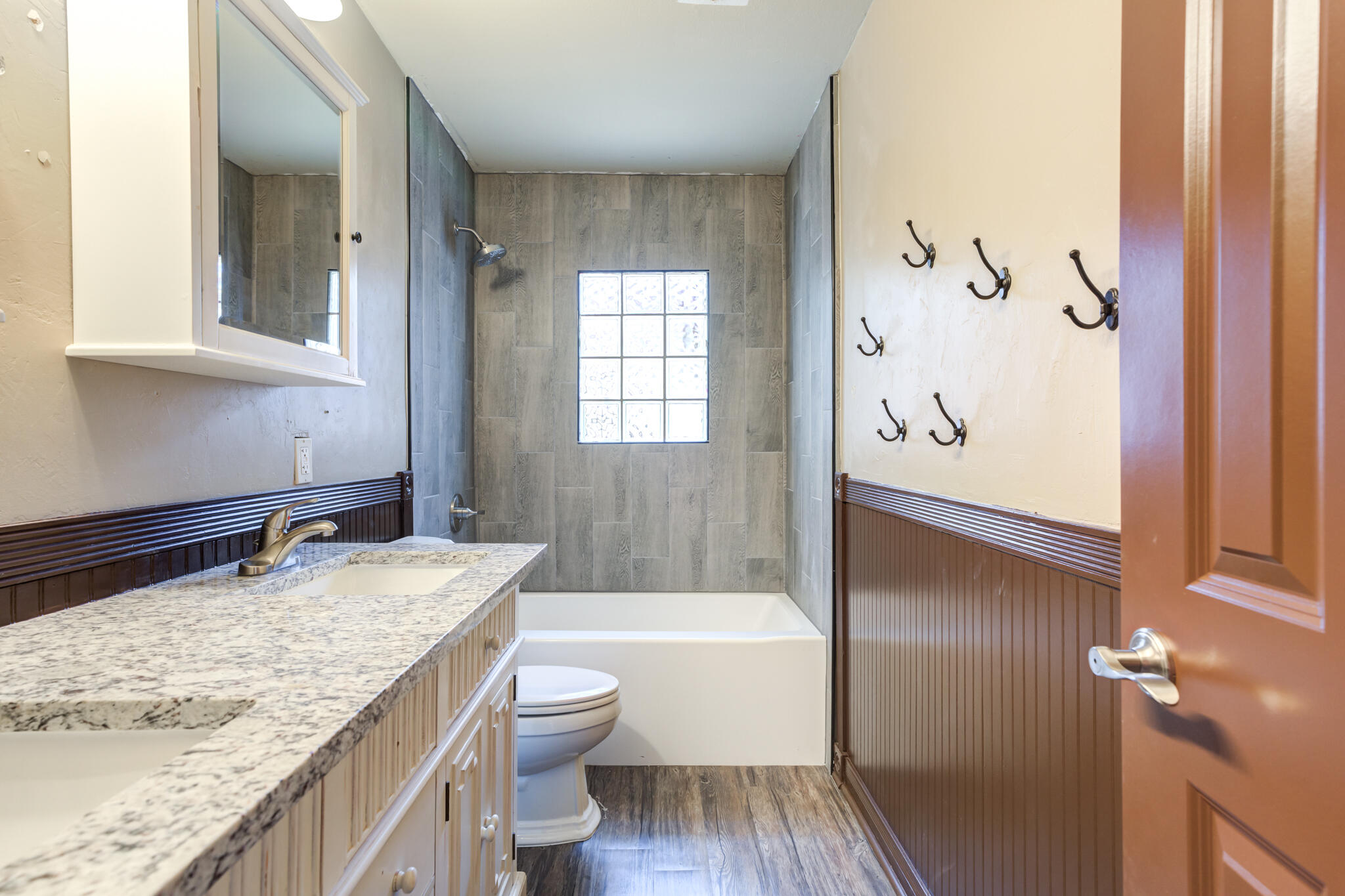 3511 44th Street Lubbock, TX 79413 - Photo 16 of 24 a bathroom with a granite countertop bathtub sink vanity mirror and toilet