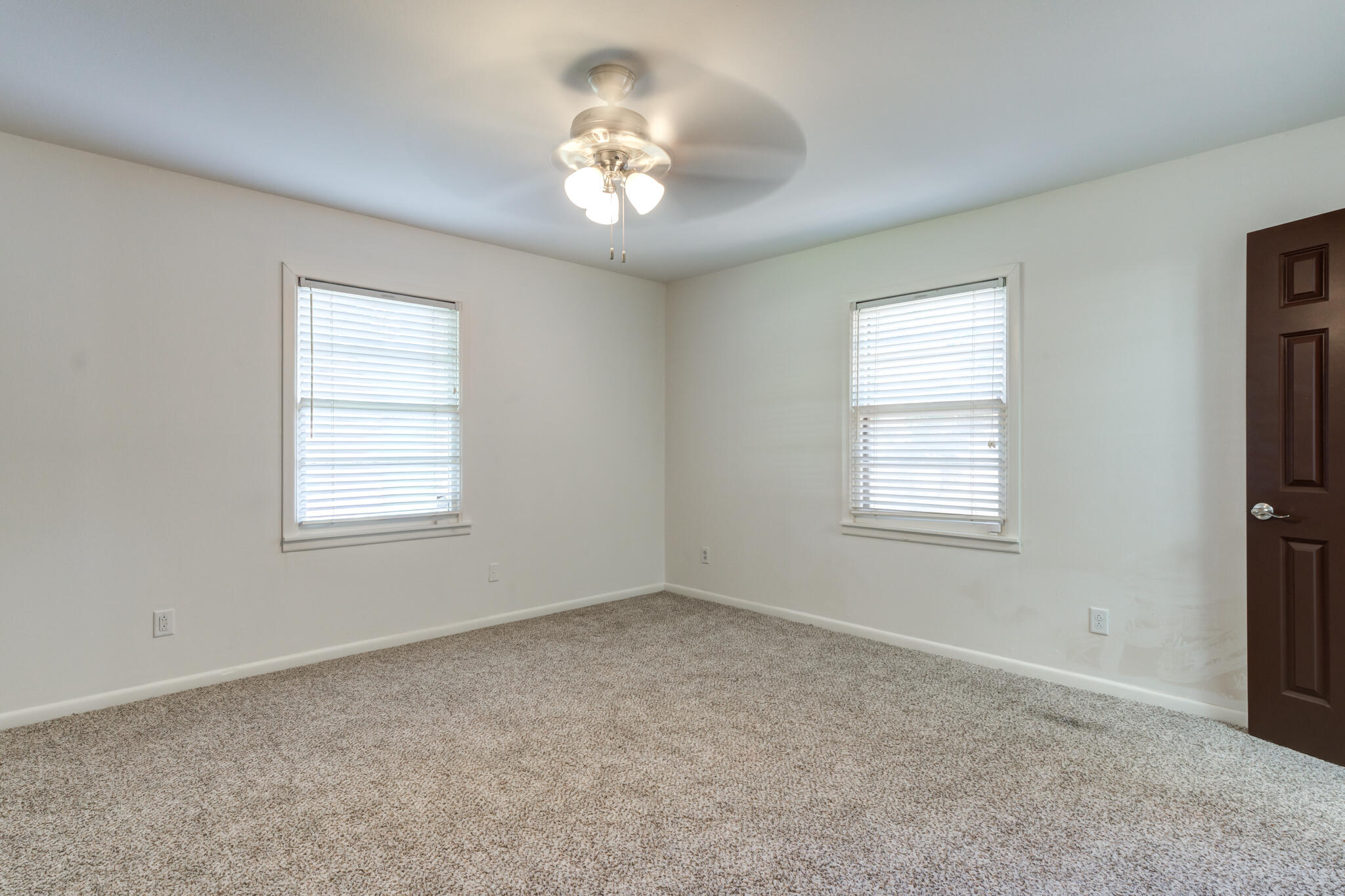 3511 44th Street Lubbock, TX 79413 - Photo 20 of 24 a view of an empty room with a window and chandelier fan