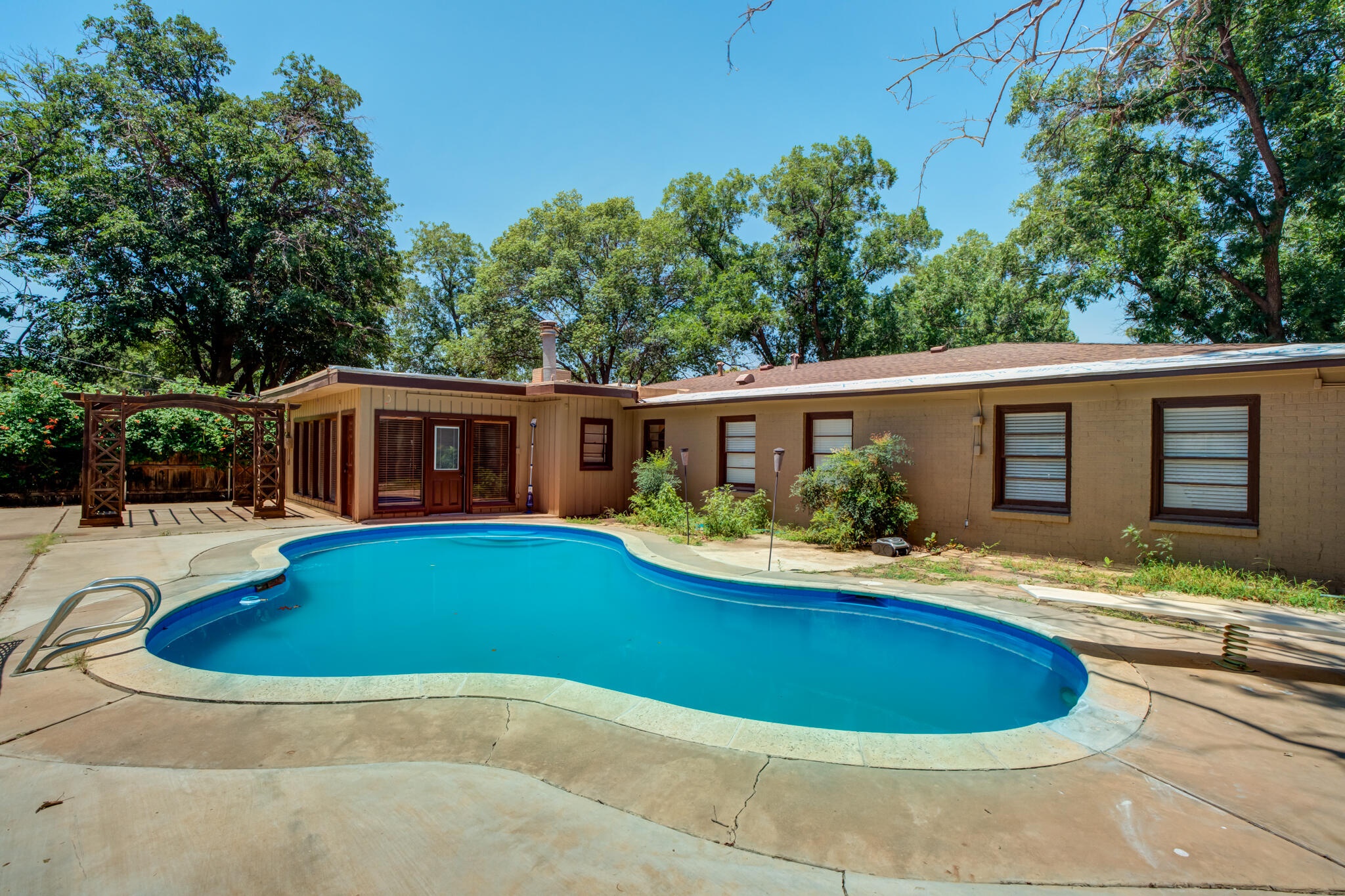3511 44th Street Lubbock, TX 79413 - Photo 23 of 24 a view of house with swimming pool outdoor seating and house in the background