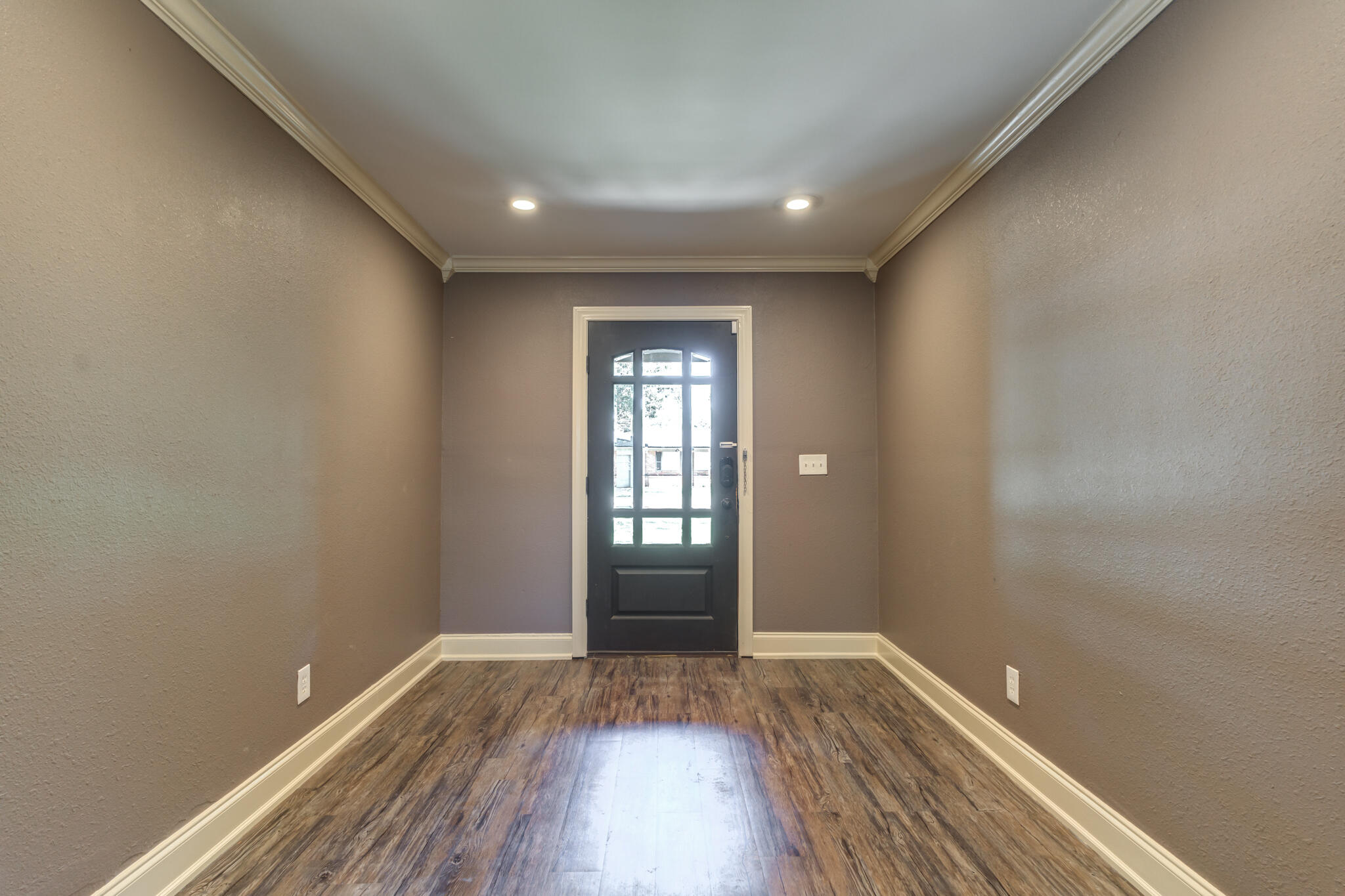 3511 44th Street Lubbock, TX 79413 - Photo 4 of 24 a view of an empty room with wooden floor and a window