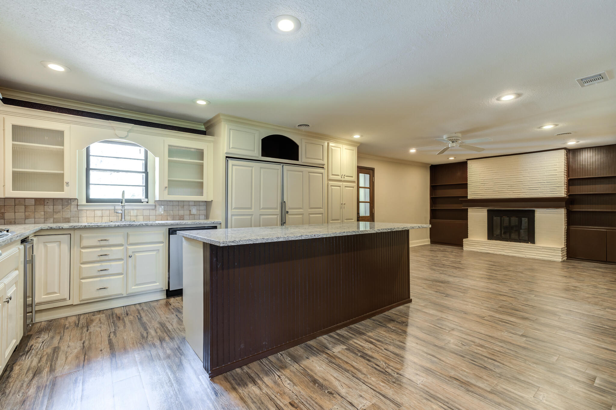 3511 44th Street Lubbock, TX 79413 - Photo 7 of 24 a large kitchen with stainless steel appliances granite countertop a stove and a wooden floors