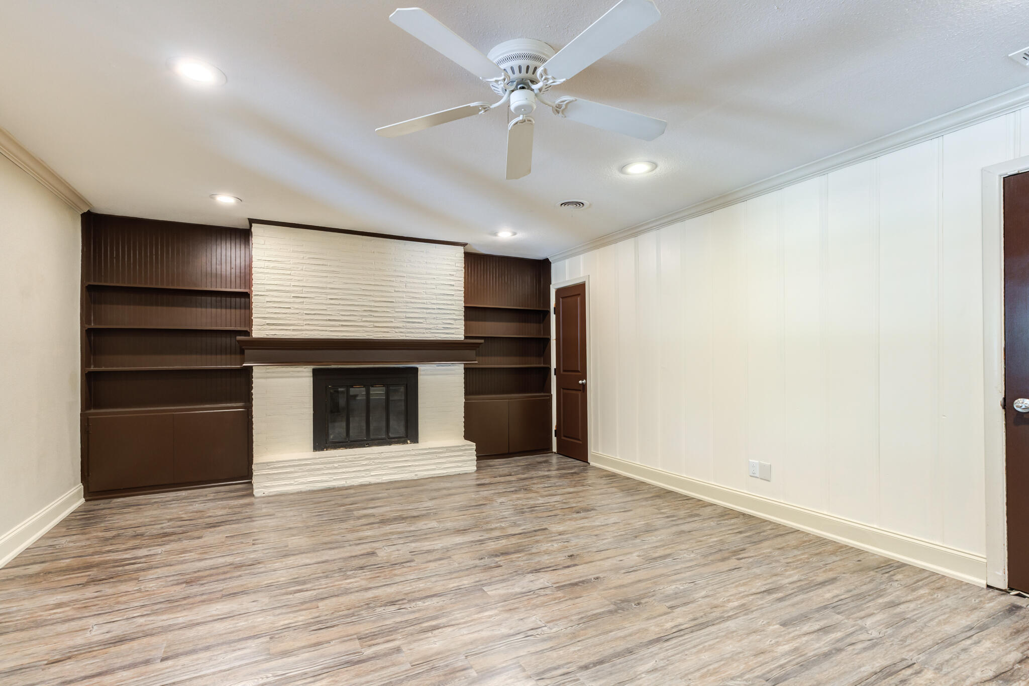 3511 44th Street Lubbock, TX 79413 - Photo 9 of 24 a view of an empty room with a kitchen and a window