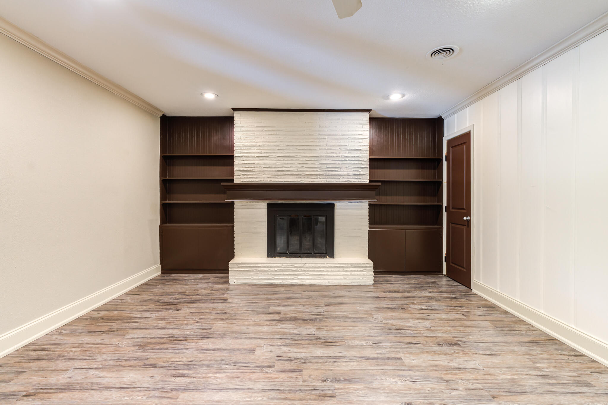 3511 44th Street Lubbock, TX 79413 - Photo 10 of 24 a view of kitchen and empty room with wooden floor