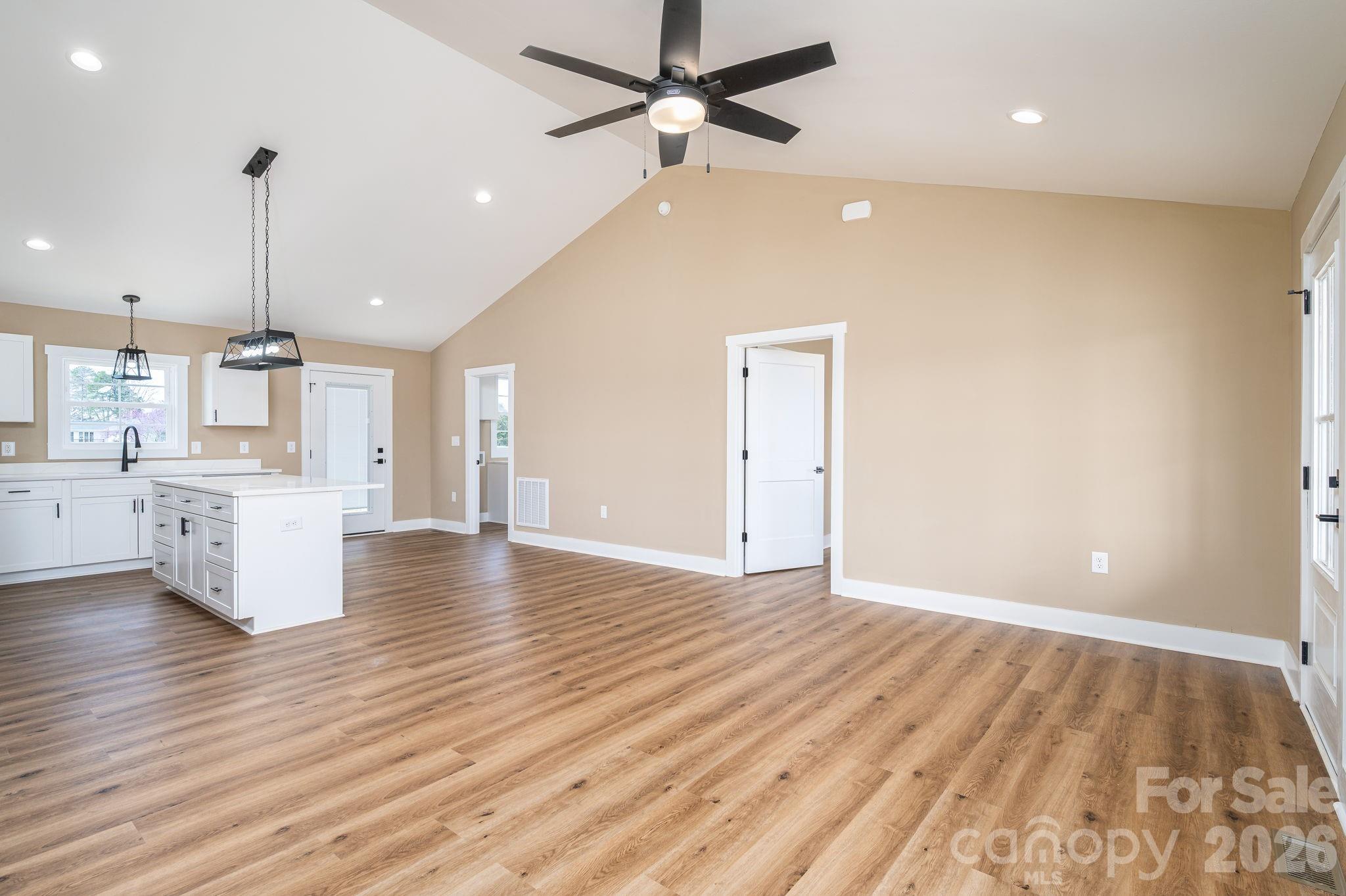 347 Old Belwood Road Lawndale, NC 28090 - Photo 11 of 31 a view of an empty room and kitchen with wooden floor