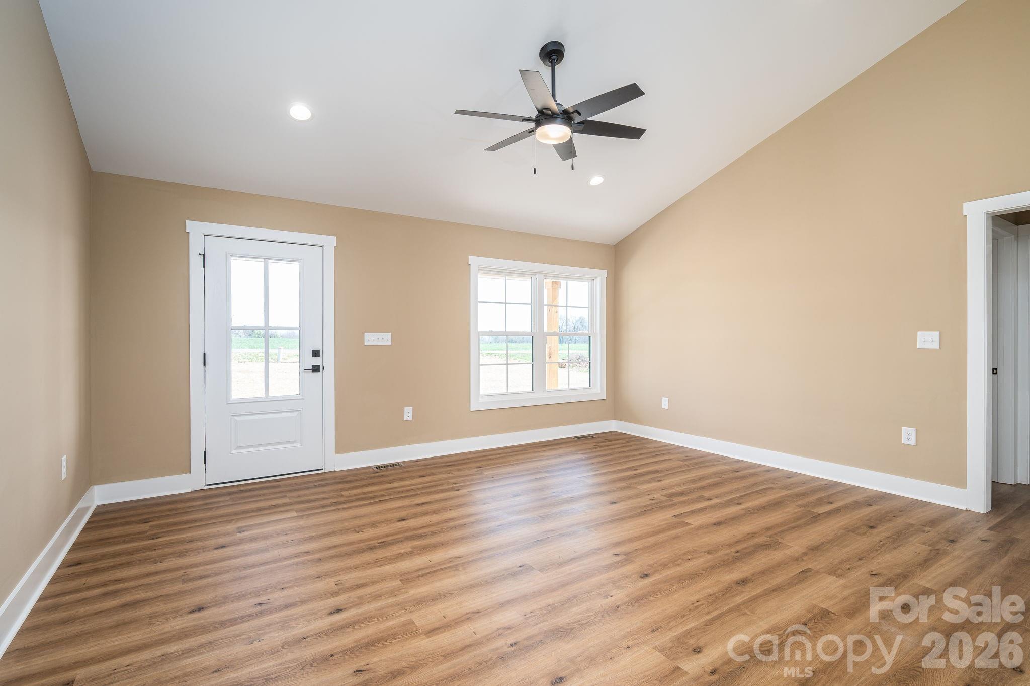 347 Old Belwood Road Lawndale, NC 28090 - Photo 12 of 31 a view of an empty room with window and wooden floor