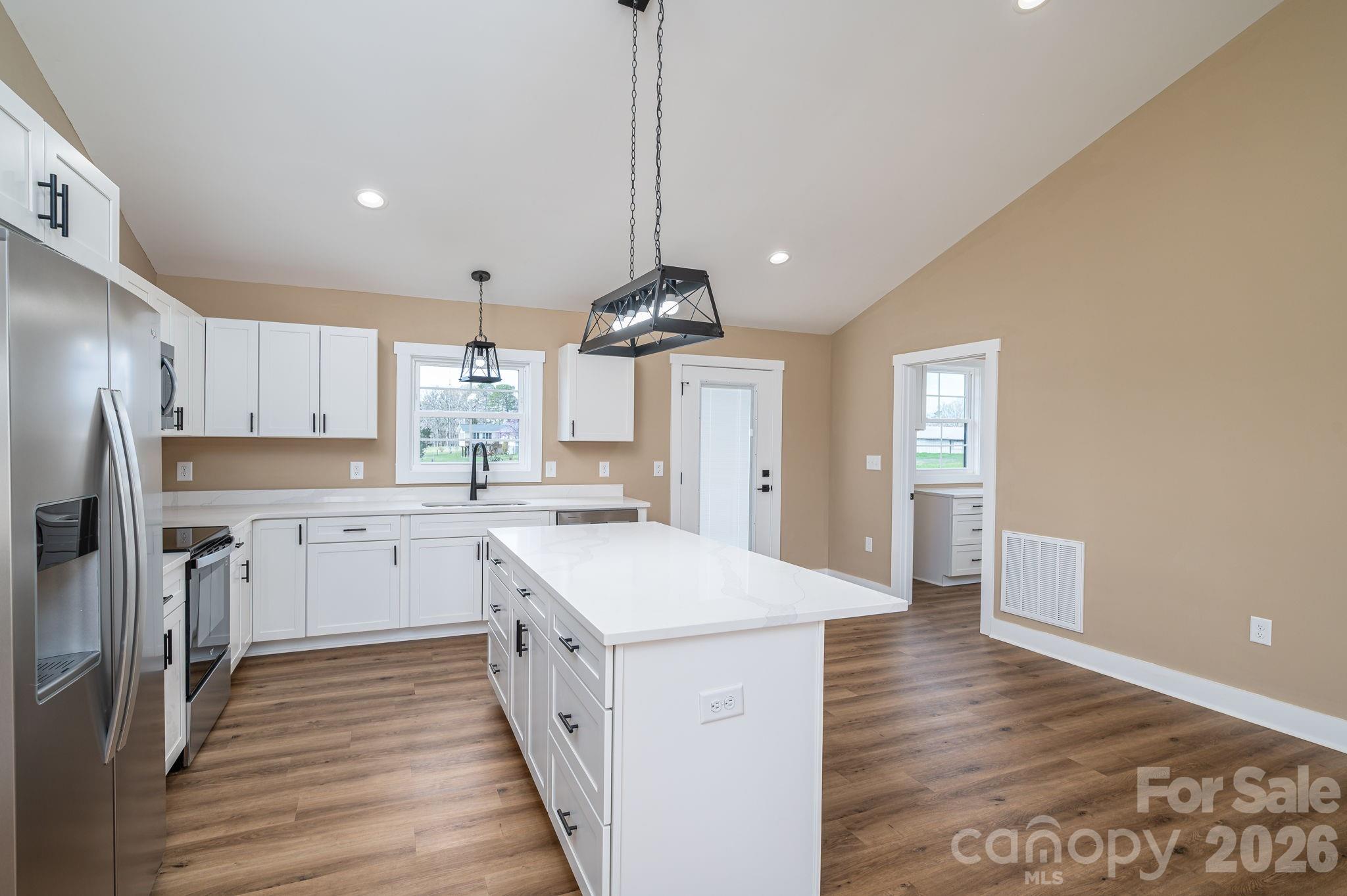 347 Old Belwood Road Lawndale, NC 28090 - Photo 15 of 31 a kitchen with sink a refrigerator and wooden floor