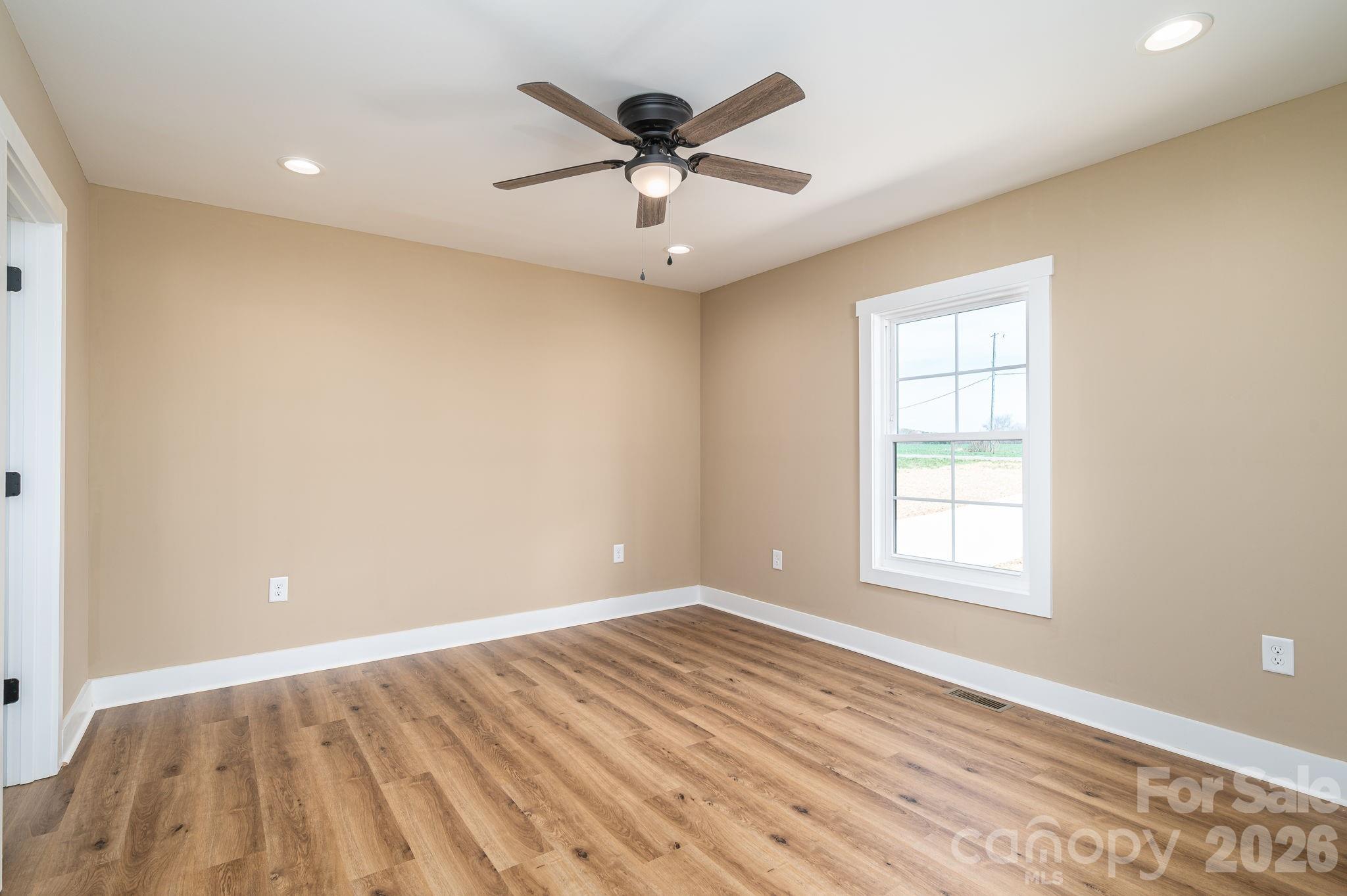 347 Old Belwood Road Lawndale, NC 28090 - Photo 18 of 31 wooden floor in an empty room with a window