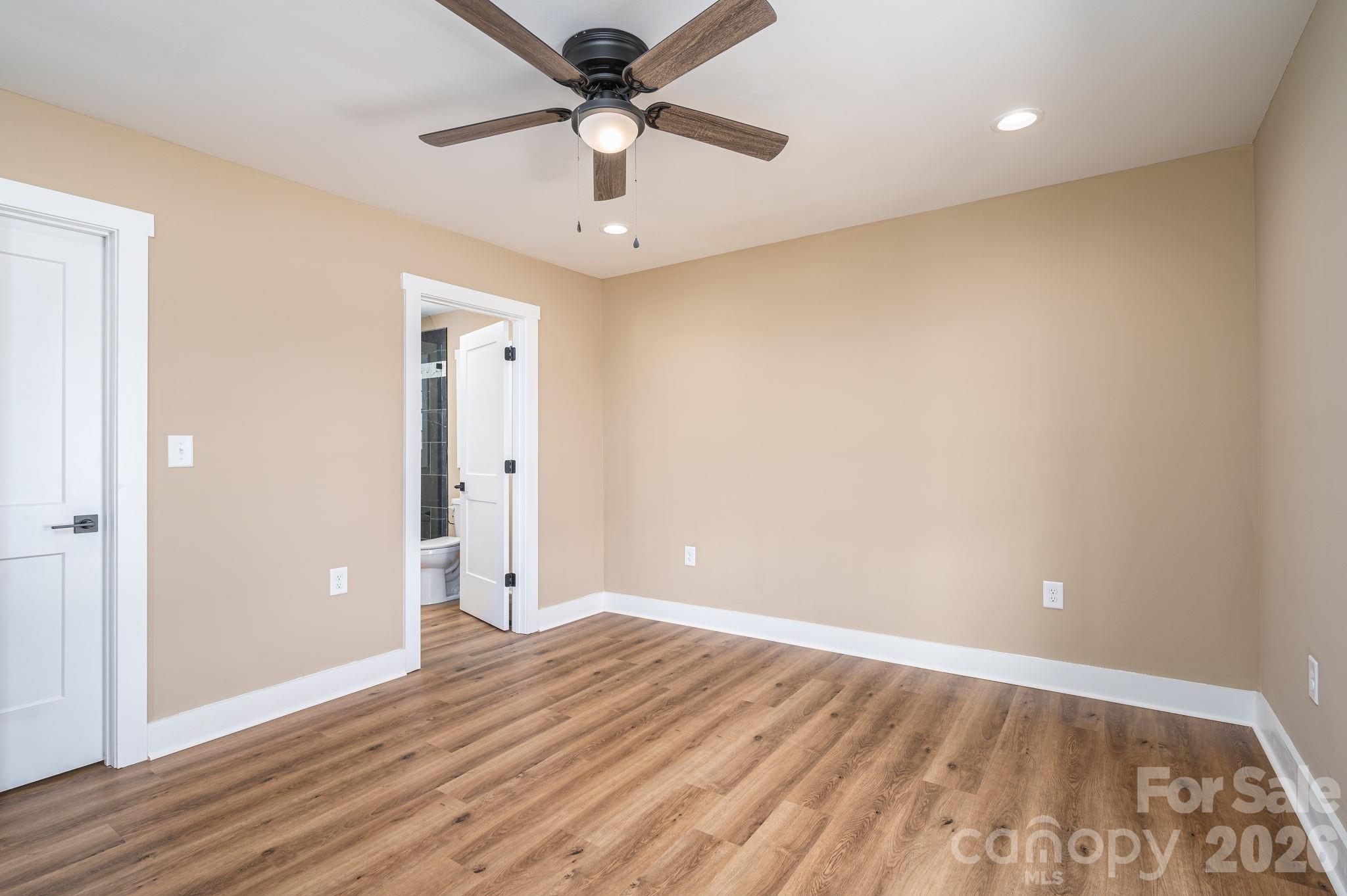 347 Old Belwood Road Lawndale, NC 28090 - Photo 19 of 31 an empty room with wooden floor and windows
