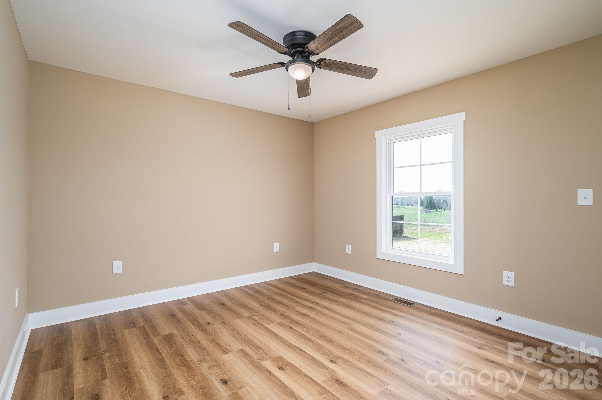 347 Old Belwood Road Lawndale, NC 28090 - Photo 23 of 31 an empty room with windows and ceiling fan