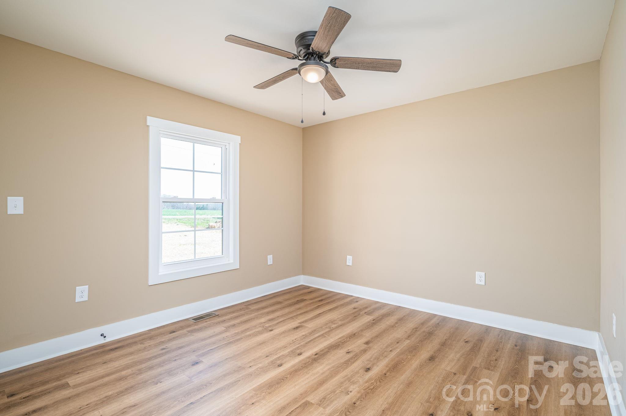 347 Old Belwood Road Lawndale, NC 28090 - Photo 25 of 31 wooden floor in an empty room with a window