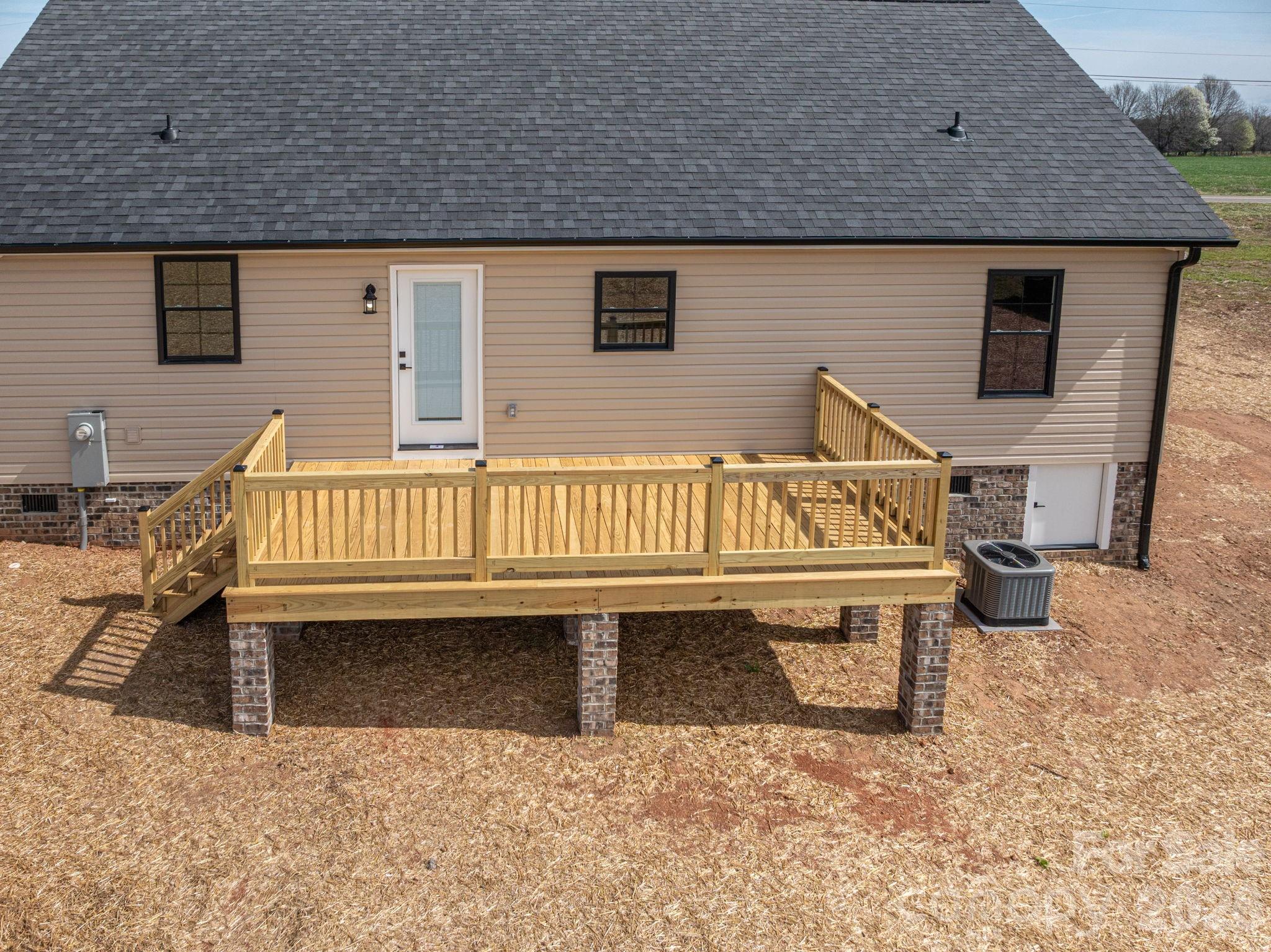 347 Old Belwood Road Lawndale, NC 28090 - Photo 29 of 31 a view of a house with wooden deck and furniture