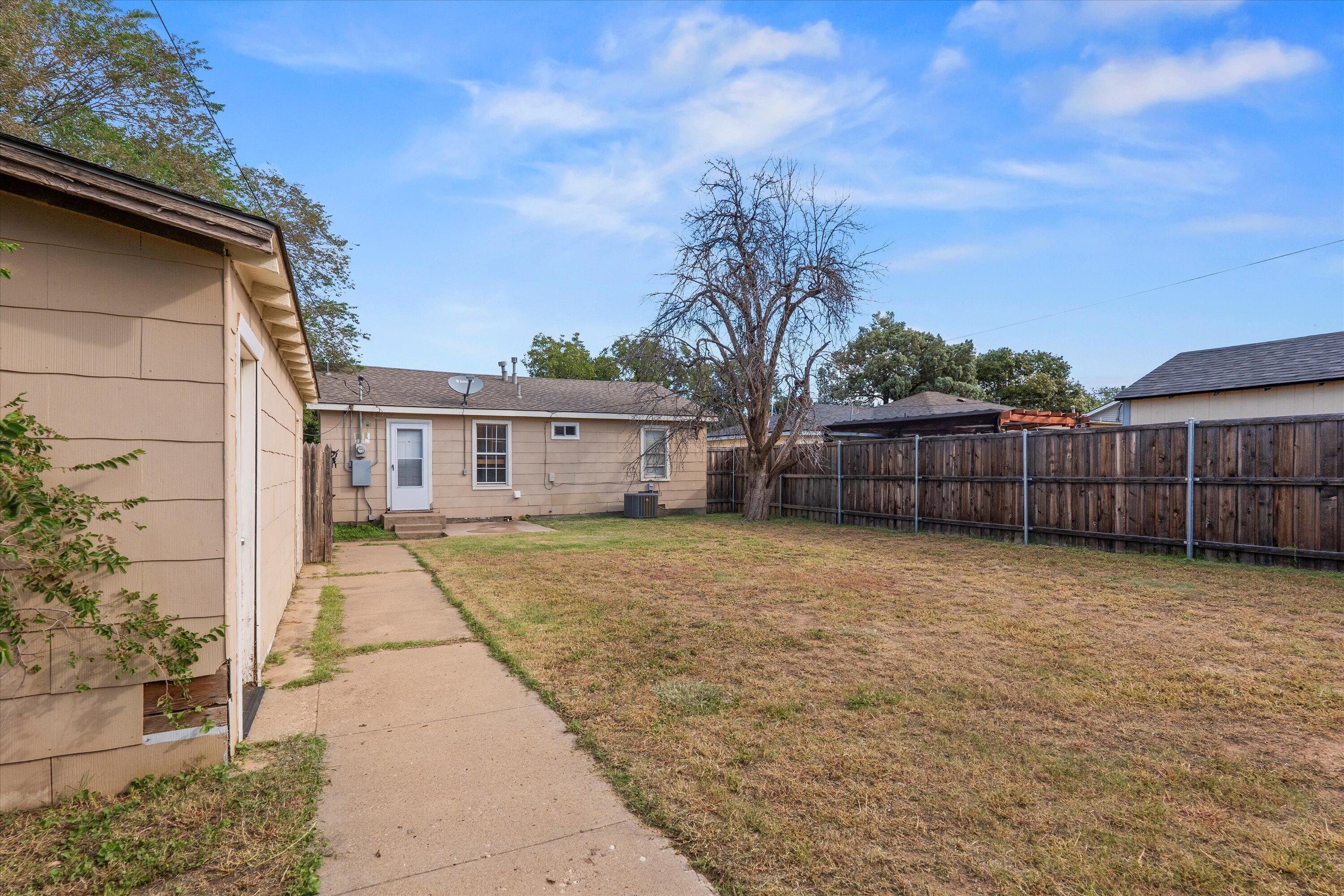 4315 33rd Street Lubbock, TX 79410 - Photo 12 of 16 a front view of a house with a garden