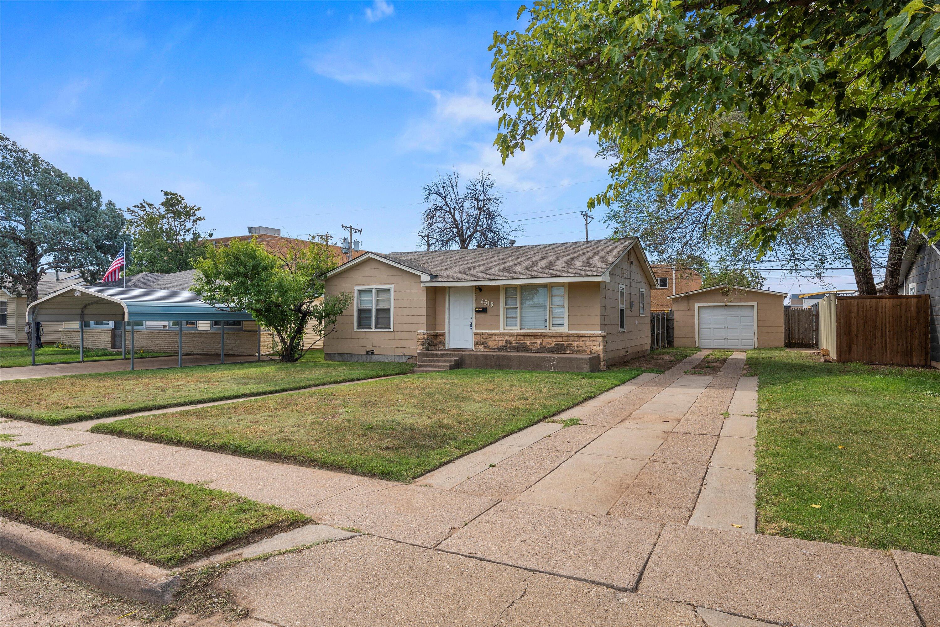 4315 33rd Street Lubbock, TX 79410 - Photo 16 of 16 a front view of a house with a yard