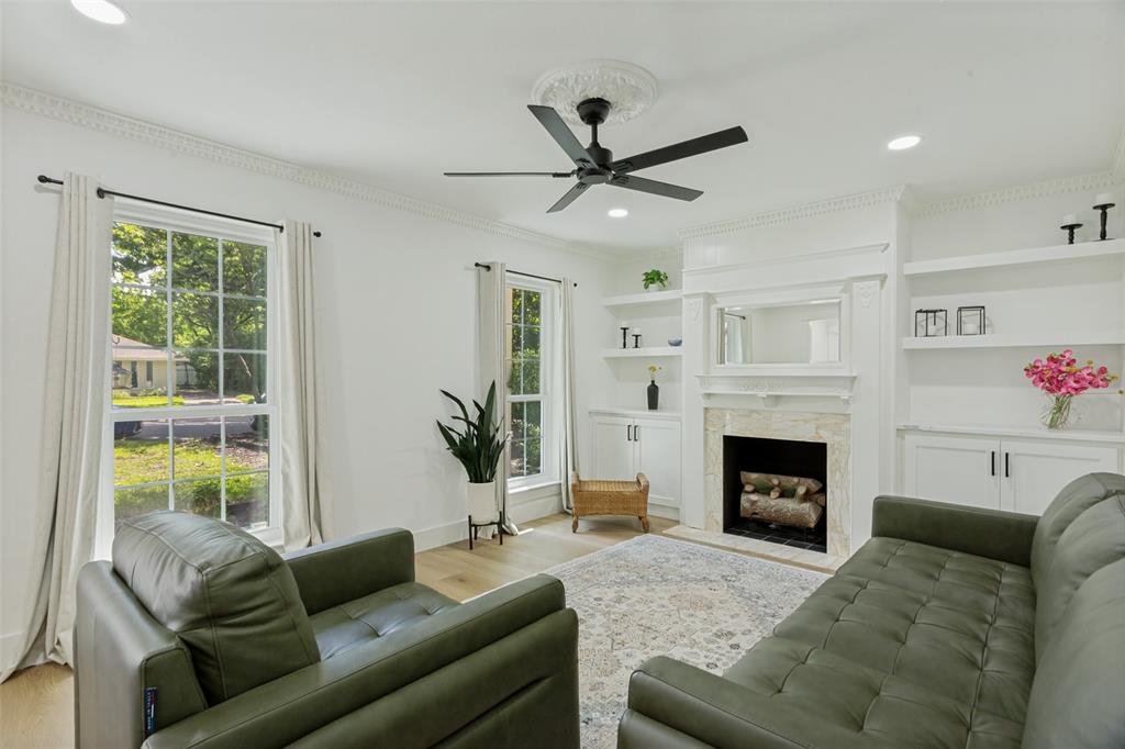 4316 Springbranch Drive Benbrook, TX 76116 - Photo 7 of 39 Spacious living area featuring light wood-finish flooring, a ceiling fan with decorative medallion, and crown molding