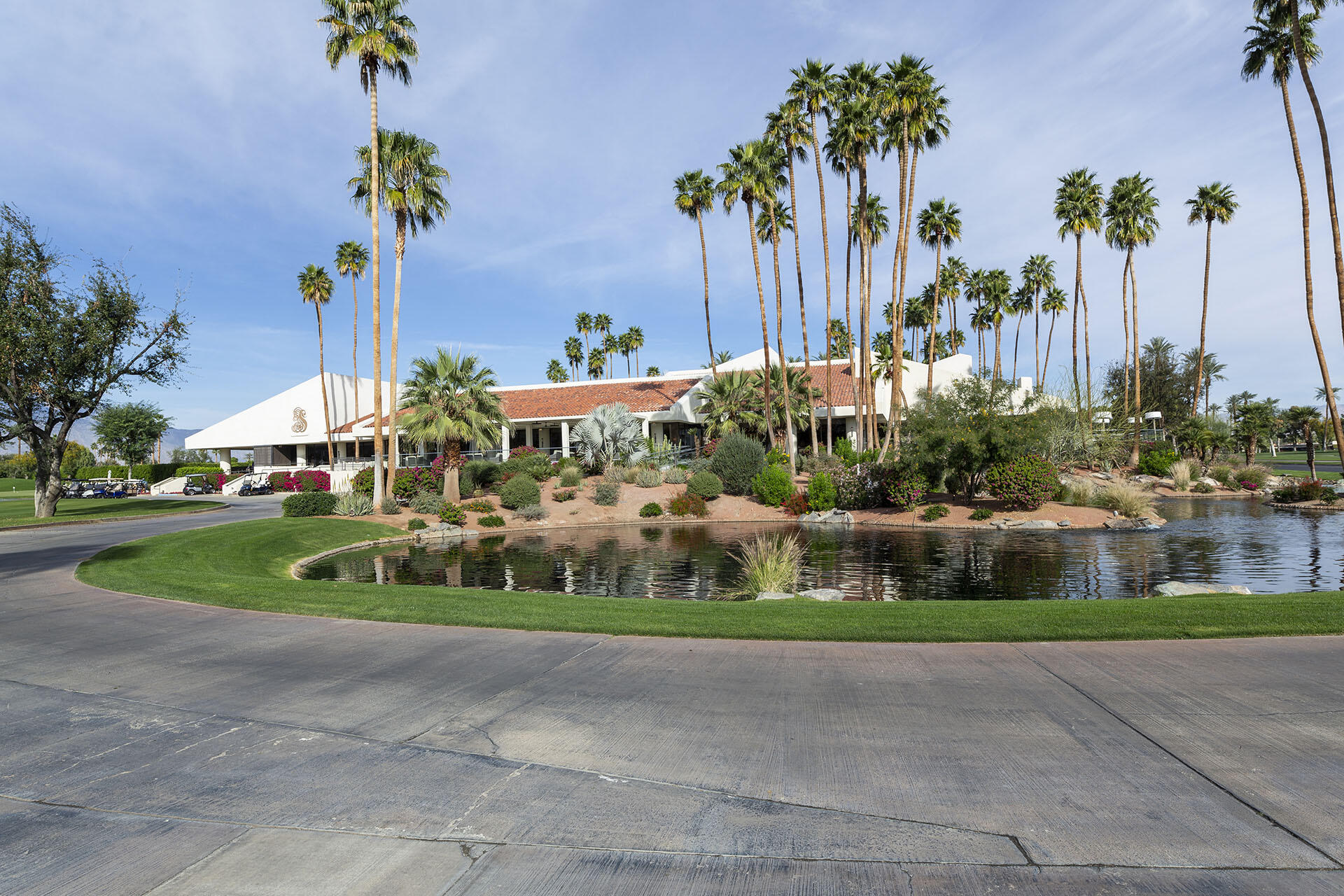 32 Colgate Drive Rancho Mirage, CA 92270 - Photo 49 of 51 a front view of a house with a yard and potted plants