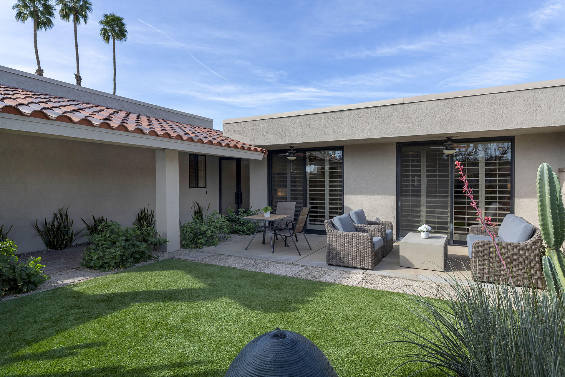 32 Colgate Drive Rancho Mirage, CA 92270 - Photo 5 of 51 a view of a patio with table and chairs potted plants and floor to ceiling window