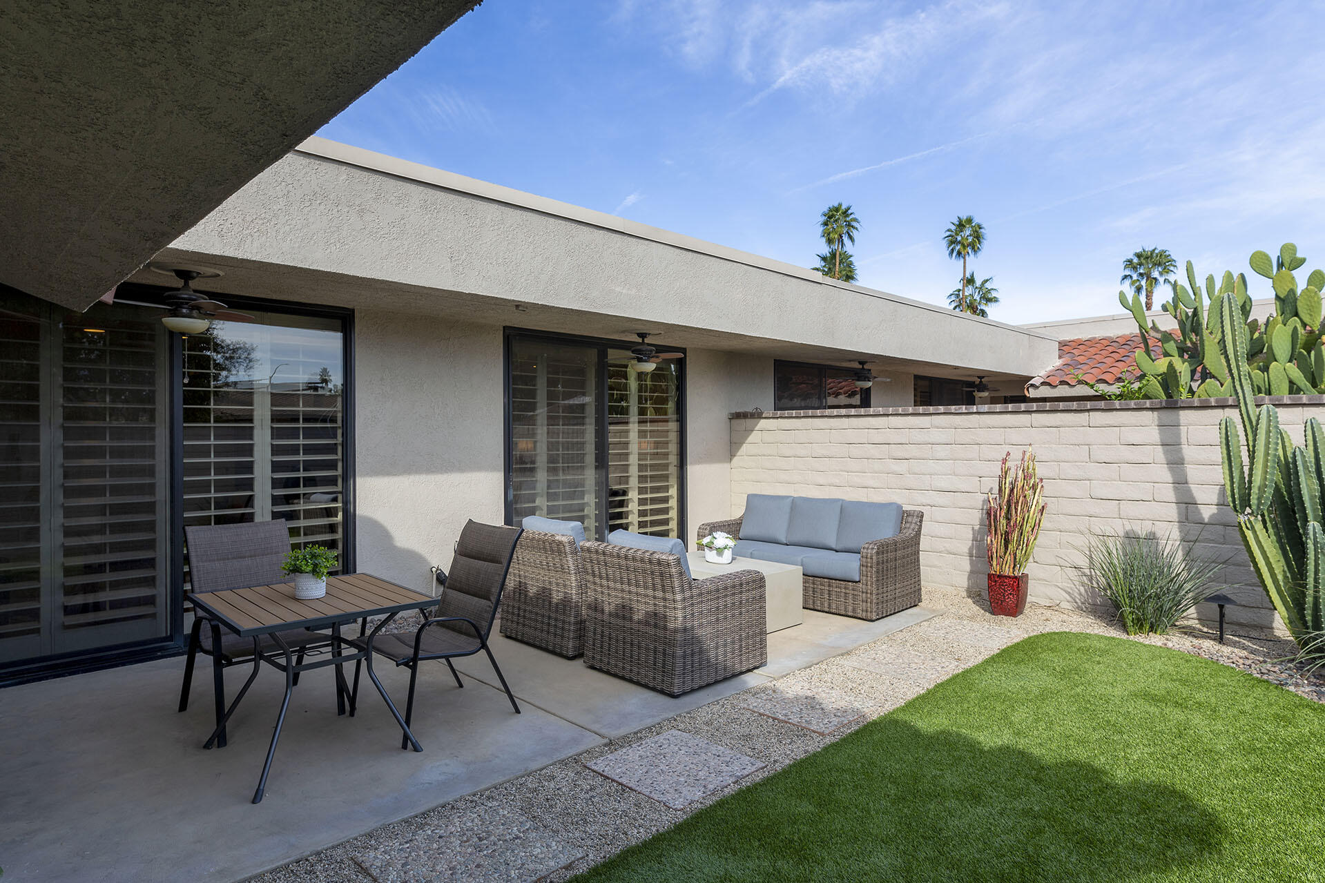 32 Colgate Drive Rancho Mirage, CA 92270 - Photo 6 of 51 a view of a patio with couches table and chairs and potted plants