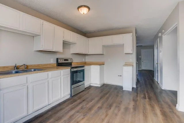 a kitchen with sink cabinets and wooden floor