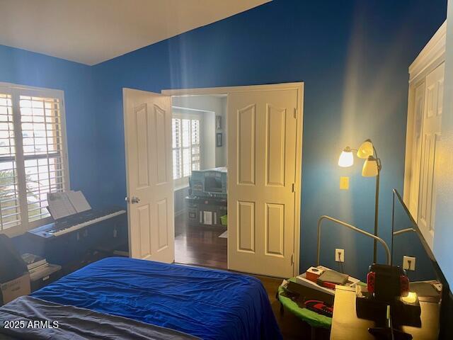 7239 West Morrow Drive Glendale, AZ 85308 - Photo 8 of 19 a bedroom with a bed and wooden floor