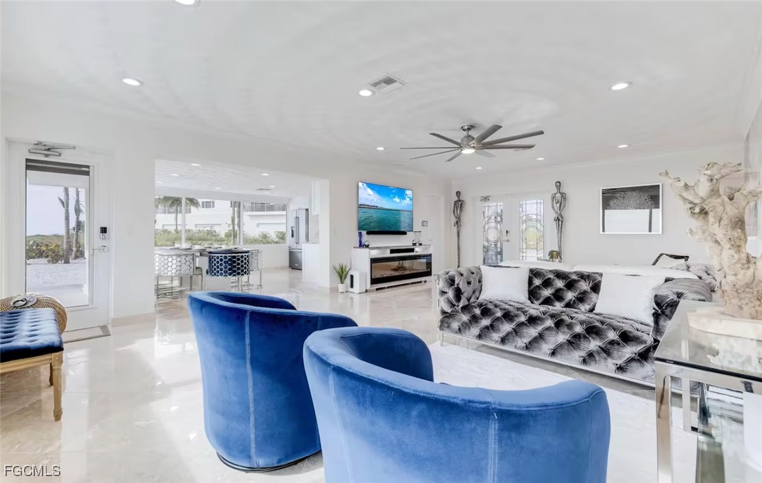 2740 North Beach Road, Unit A & B Englewood, FL 34223 - Photo 11 of 43 a living room with furniture a fireplace and a flat screen tv