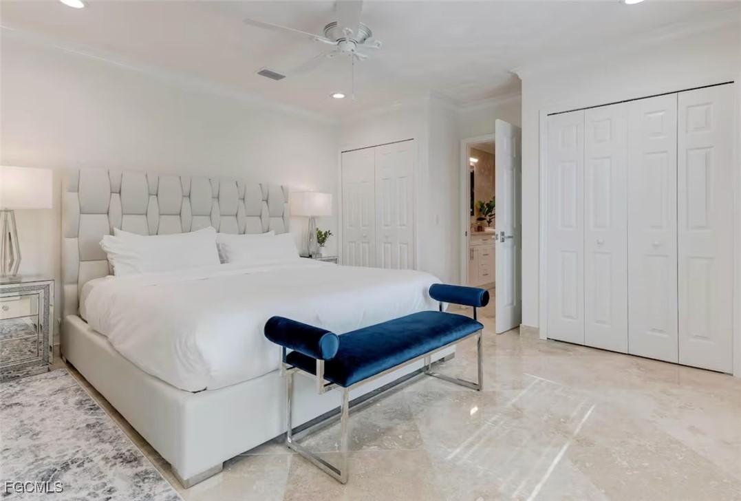 2740 North Beach Road, Unit A & B Englewood, FL 34223 - Photo 16 of 43 a spacious bedroom with a bed and a chandelier