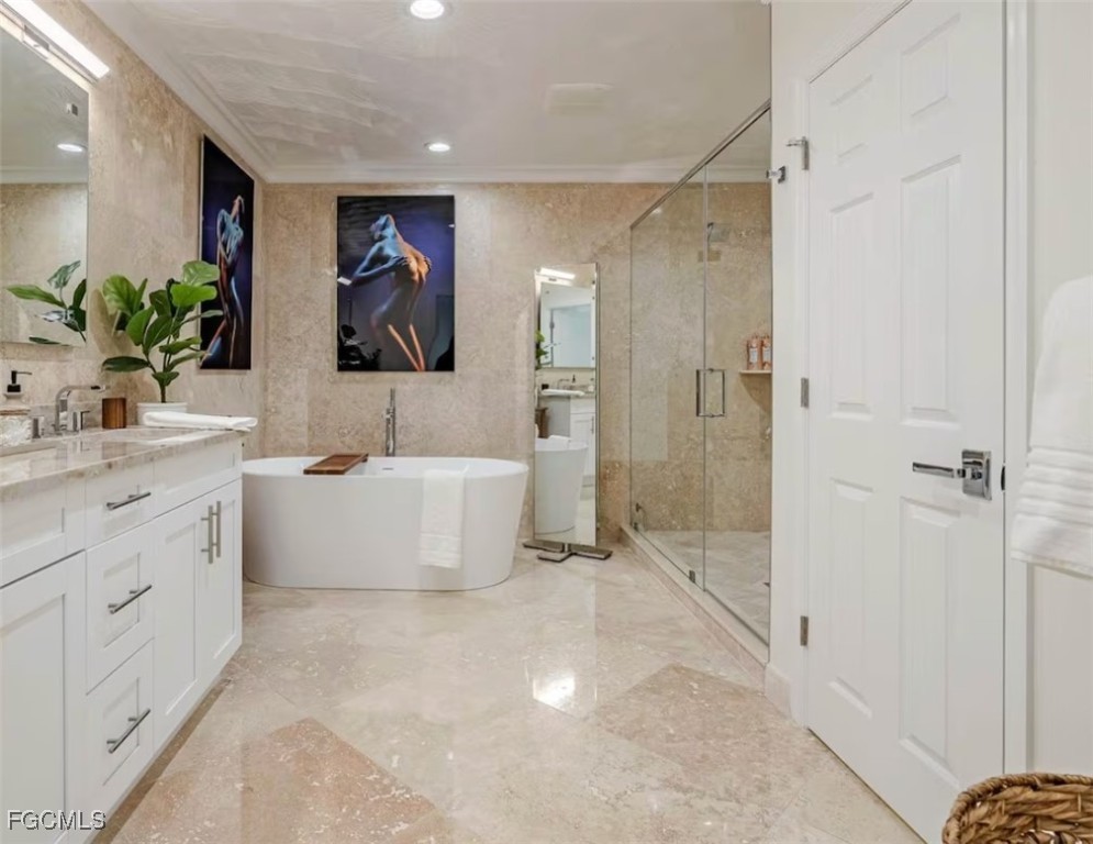 2740 North Beach Road, Unit A & B Englewood, FL 34223 - Photo 20 of 43 a bathroom with a double vanity sink a mirror a bathtub and shower