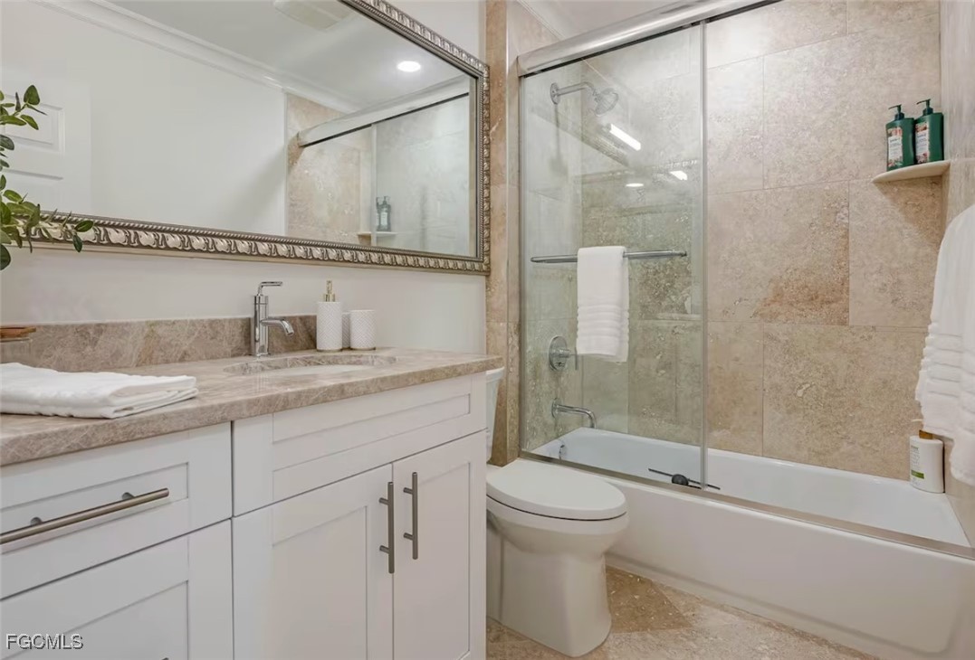 2740 North Beach Road, Unit A & B Englewood, FL 34223 - Photo 21 of 43 a bathroom with a granite countertop sink a toilet and shower