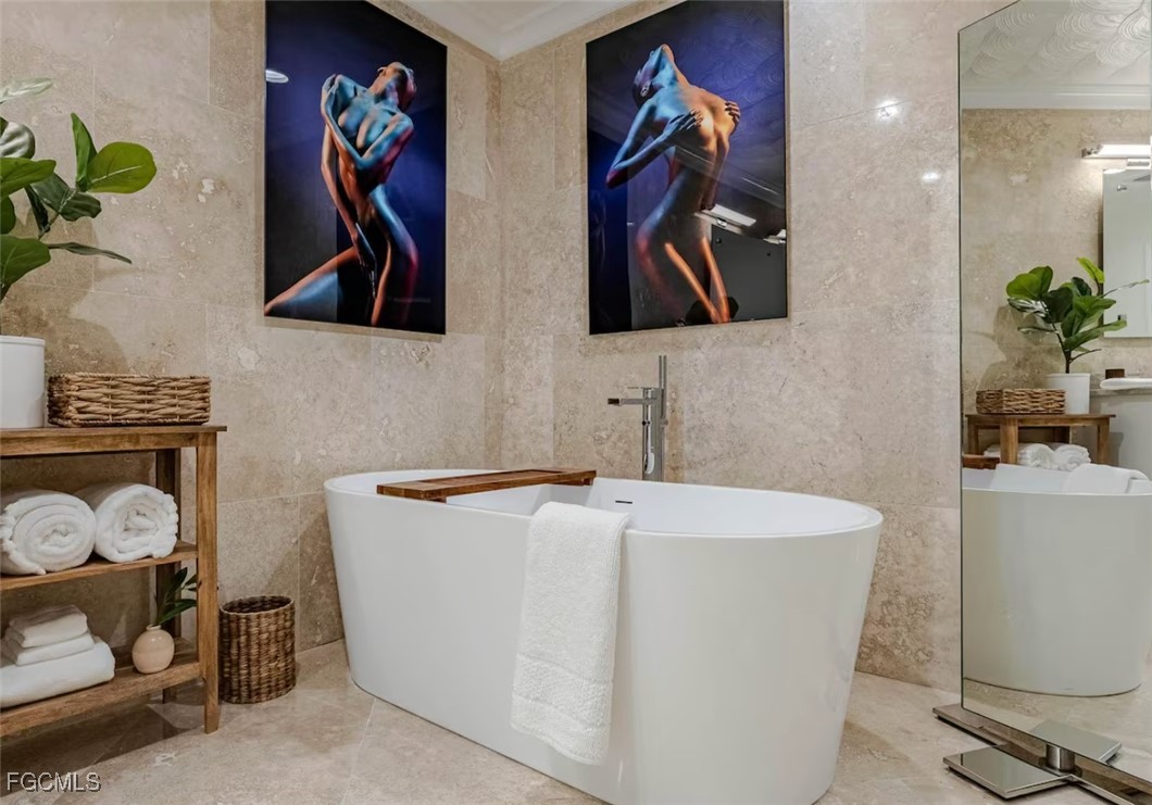 2740 North Beach Road, Unit A & B Englewood, FL 34223 - Photo 22 of 43 a bathroom with a sink a mirror and painting on the wall