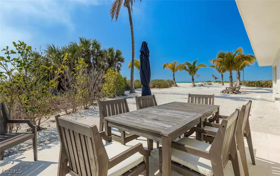 2740 North Beach Road, Unit A & B Englewood, FL 34223 - Photo 24 of 43 a view of an outside dining space with furniture and umbrella