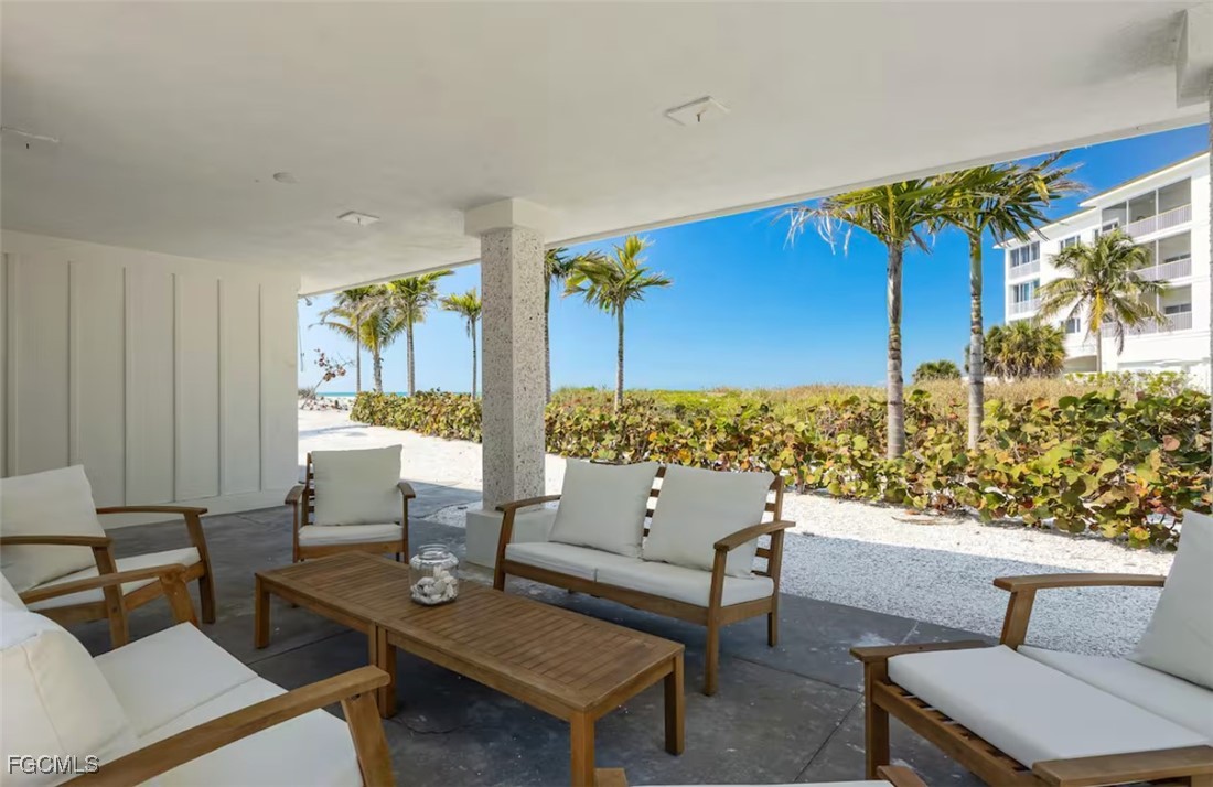 2740 North Beach Road, Unit A & B Englewood, FL 34223 - Photo 26 of 43 a living room with furniture and a floor to ceiling window