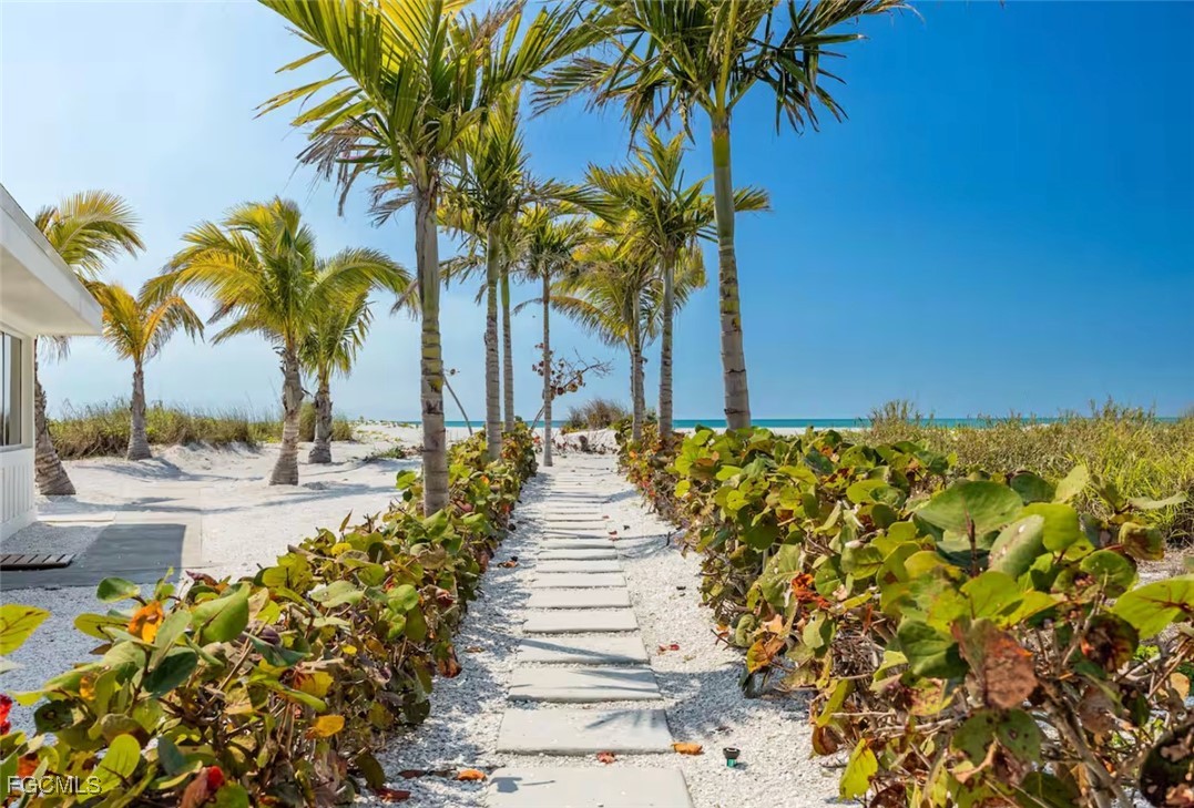 2740 North Beach Road, Unit A & B Englewood, FL 34223 - Photo 29 of 43 a row of palm trees and swimming pool in the backyard of a house