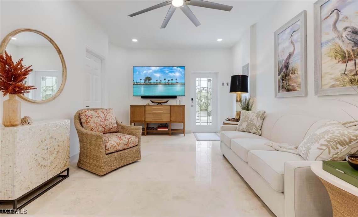 2740 North Beach Road, Unit A & B Englewood, FL 34223 - Photo 34 of 43 a living room with furniture and a flat screen tv