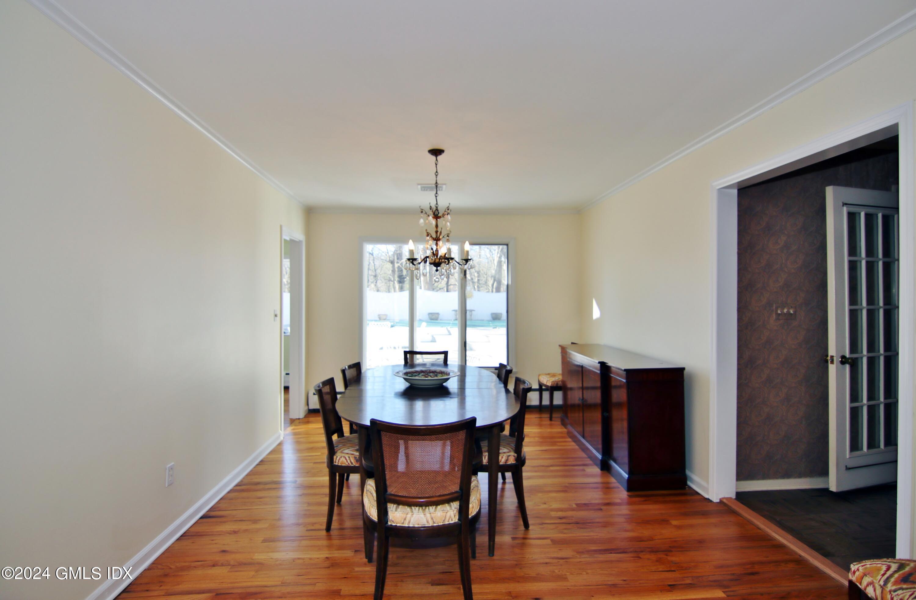 191 Sawmill Road Stamford, CT 06903 - Photo 13 of 40 a dining room with furniture window and wooden floor
