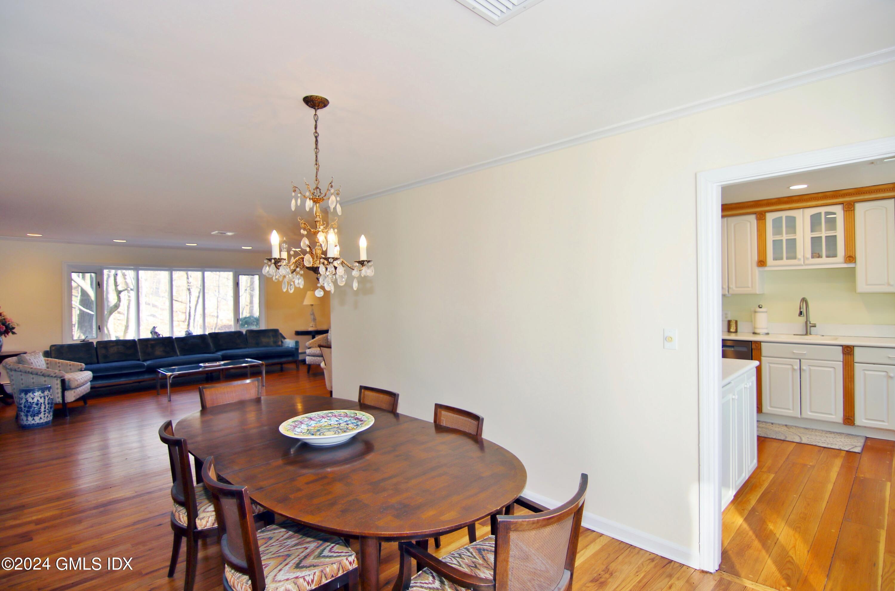 191 Sawmill Road Stamford, CT 06903 - Photo 14 of 40 a view of a dining room with furniture and chandelier