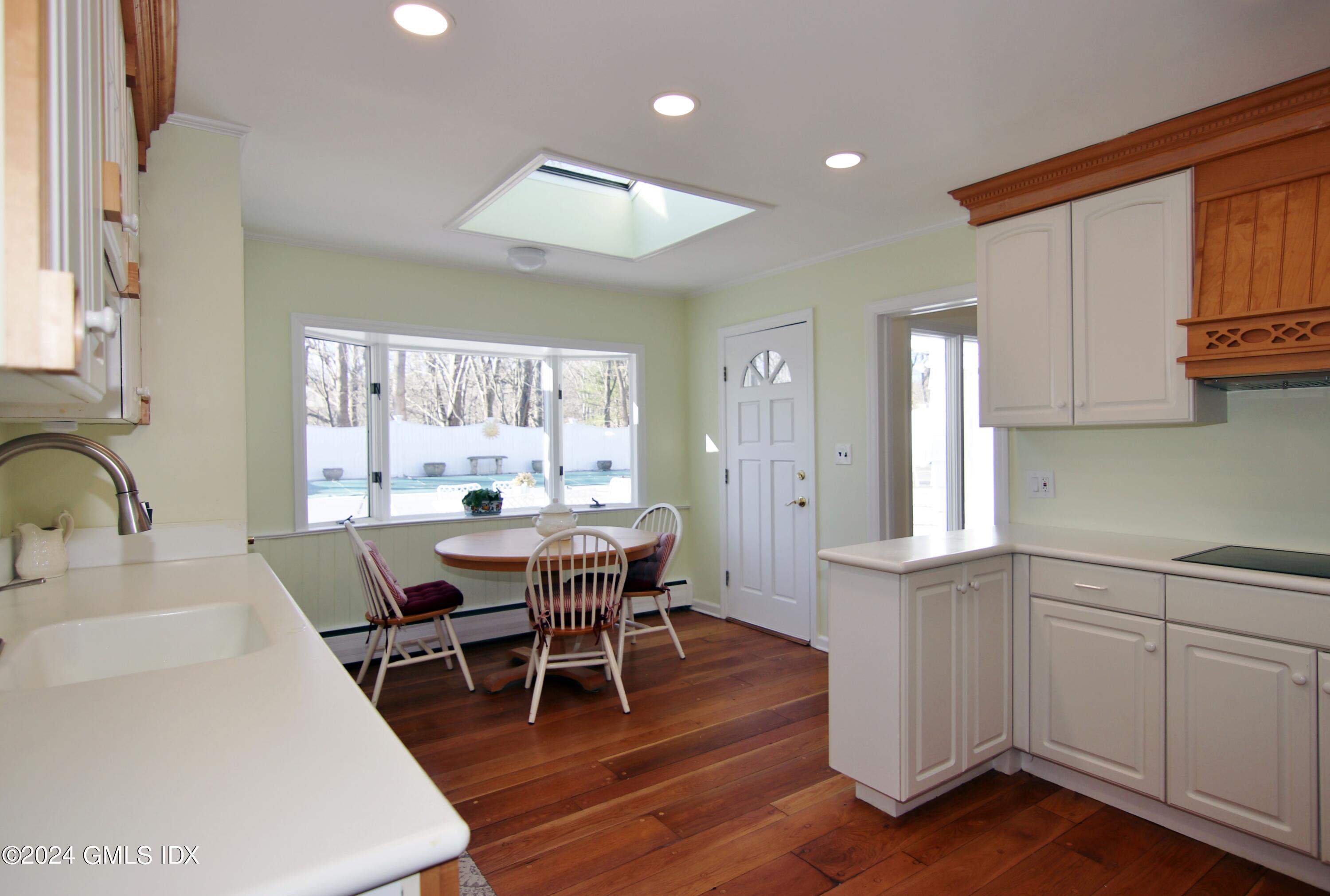 191 Sawmill Road Stamford, CT 06903 - Photo 17 of 40 a view of a dining room with furniture and wooden floor