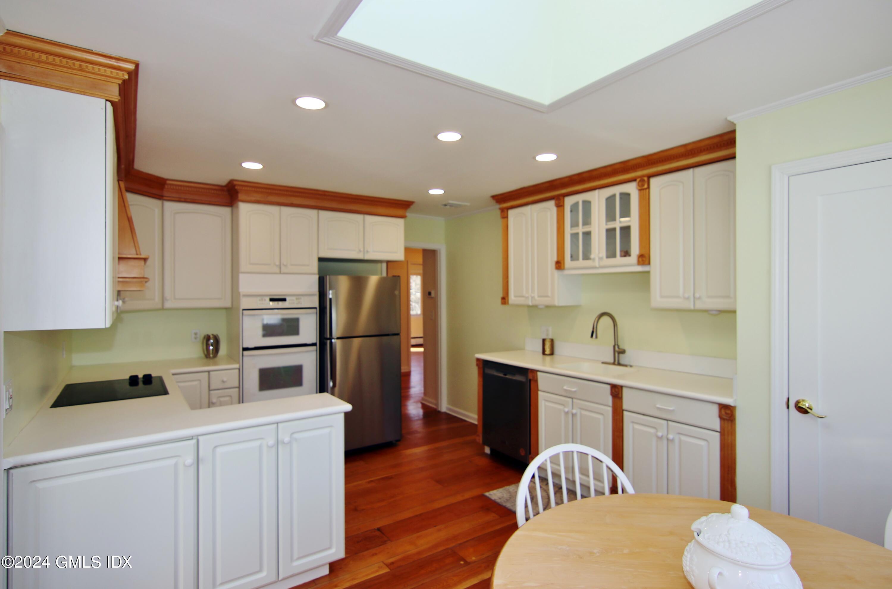 191 Sawmill Road Stamford, CT 06903 - Photo 18 of 40 a kitchen with stainless steel appliances a refrigerator and a stove top oven