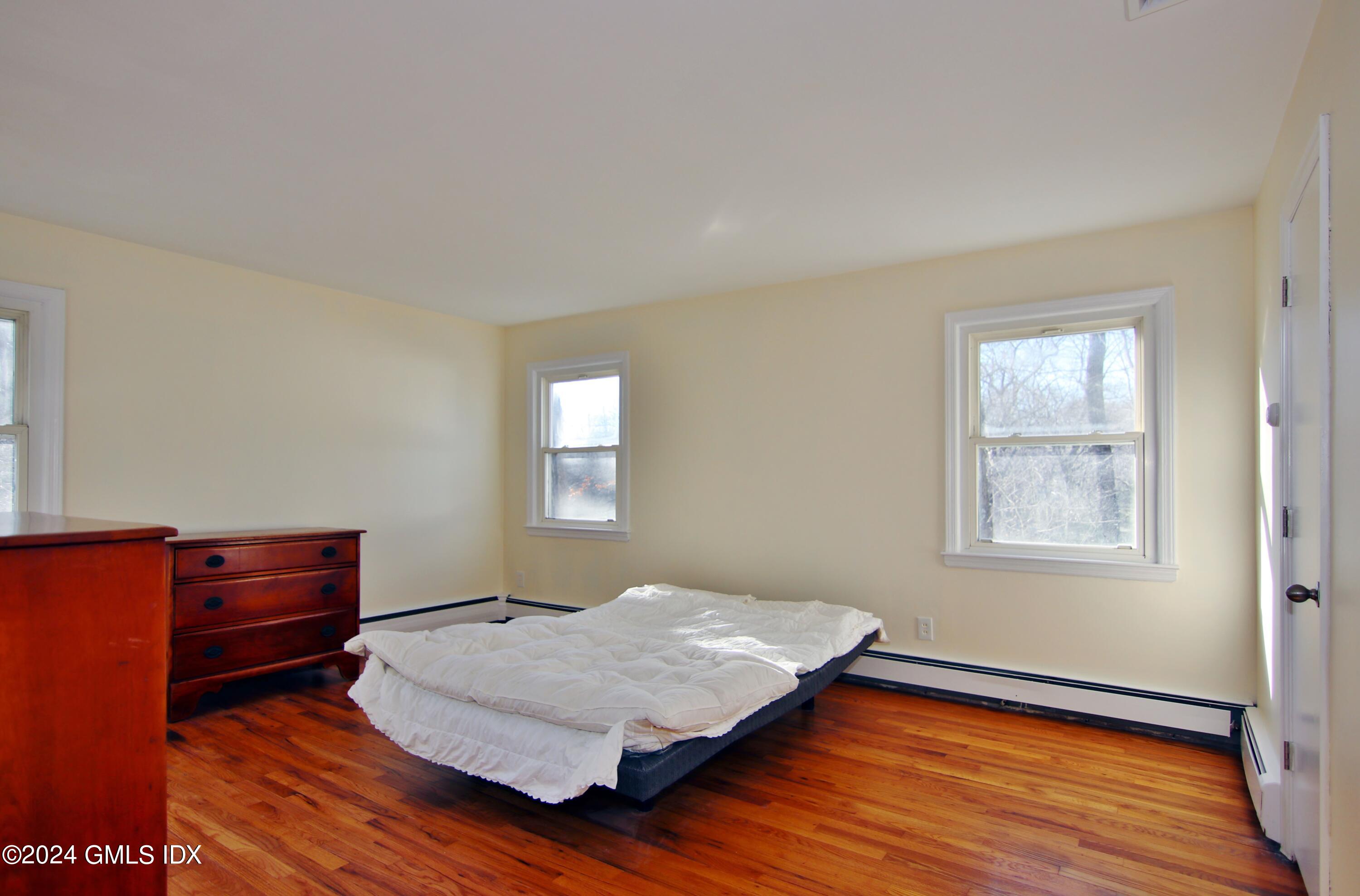 191 Sawmill Road Stamford, CT 06903 - Photo 19 of 40 a bedroom with bed cabinet and window