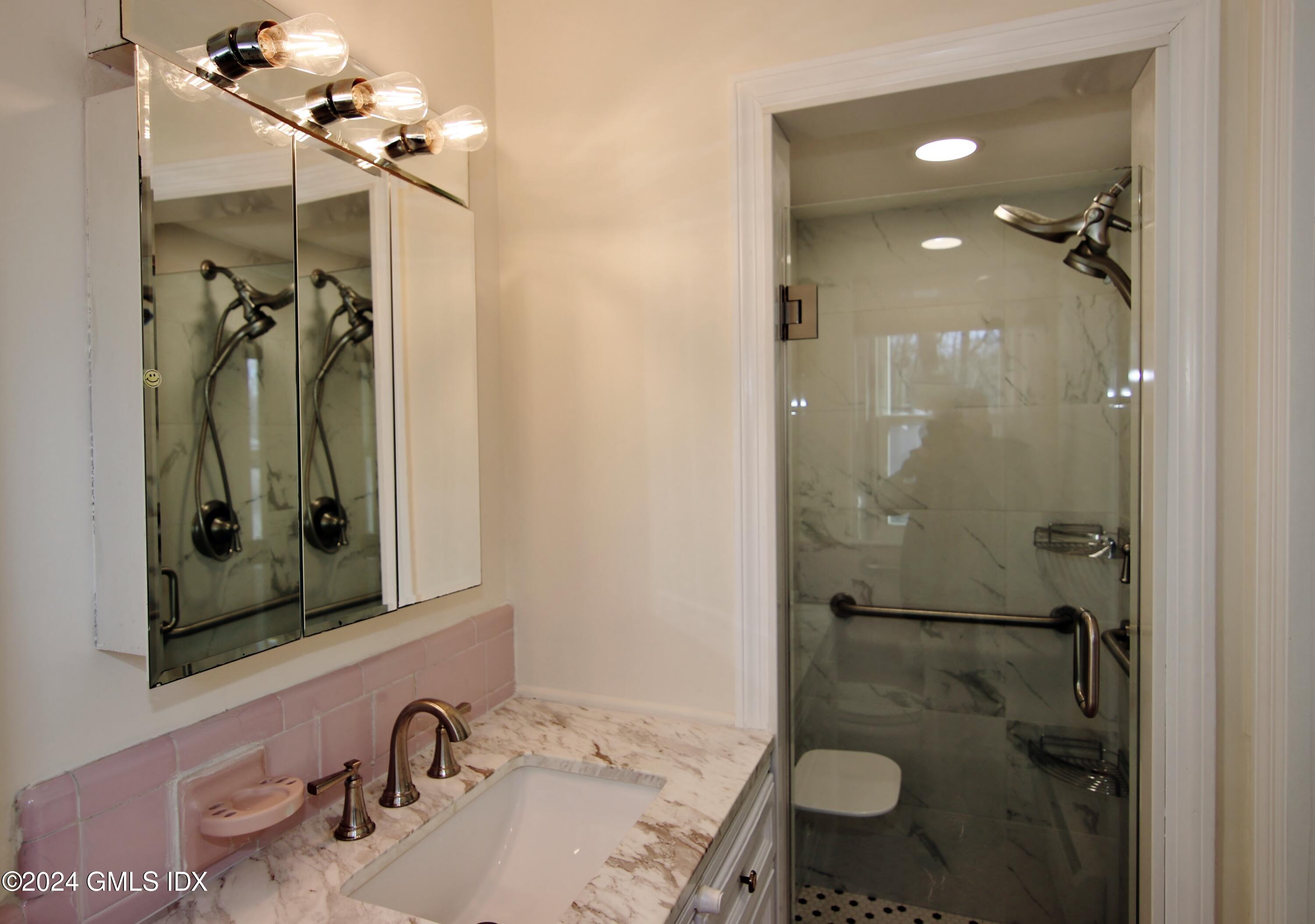 191 Sawmill Road Stamford, CT 06903 - Photo 20 of 40 a bathroom with a sink vanity granite tub shower and mirror