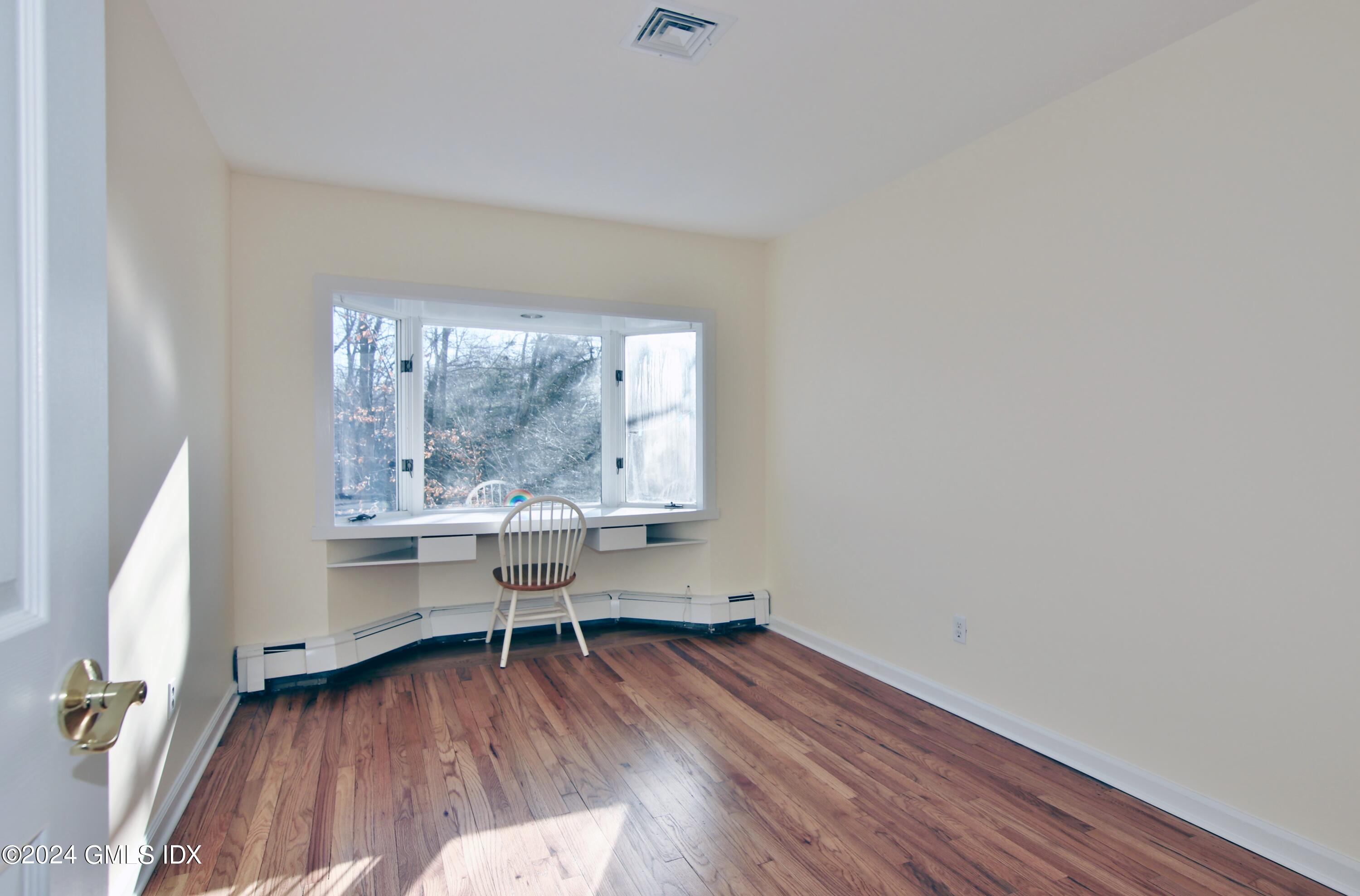 191 Sawmill Road Stamford, CT 06903 - Photo 21 of 40 a view of room with window and wooden floor