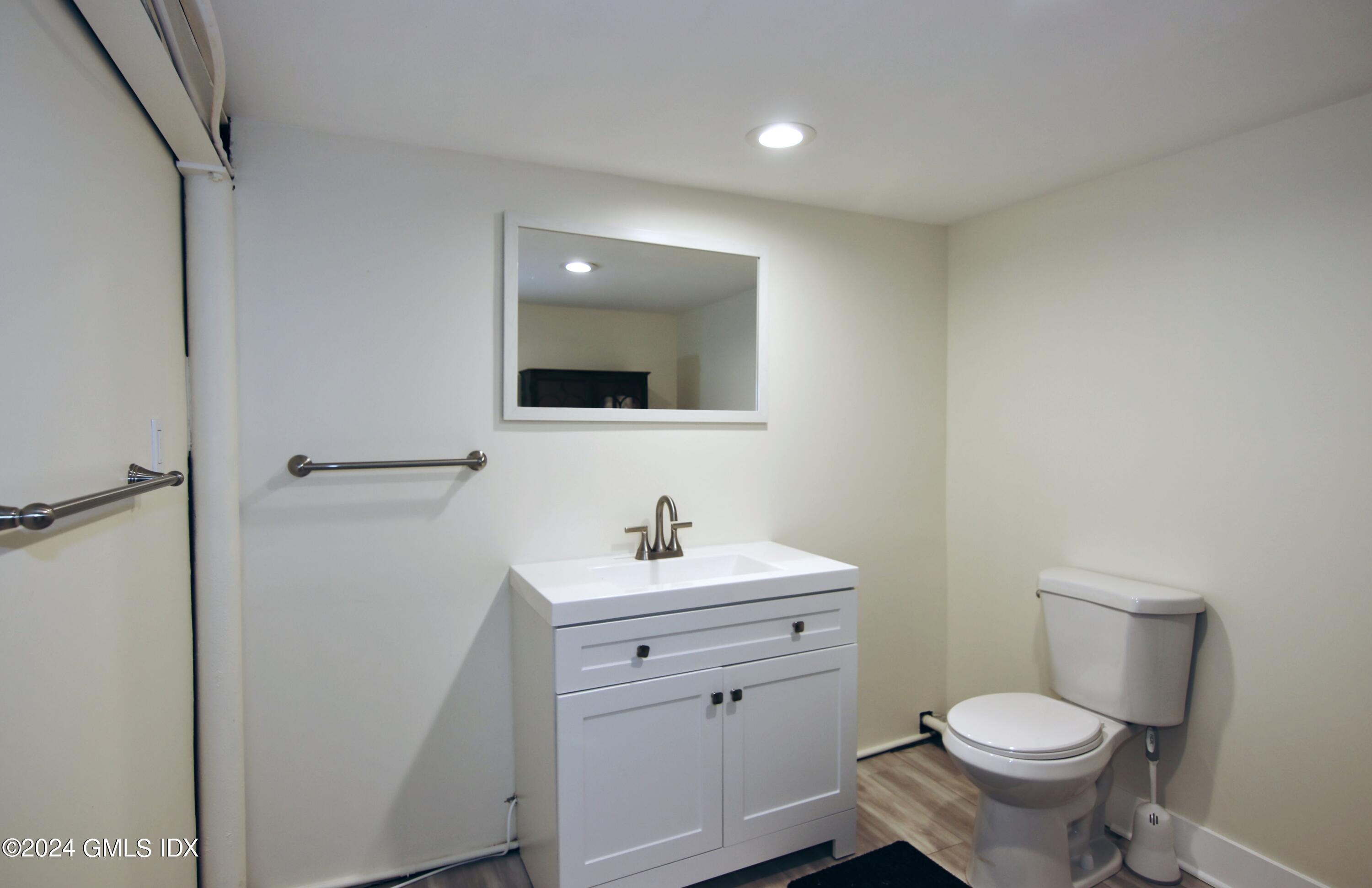 191 Sawmill Road Stamford, CT 06903 - Photo 28 of 40 a bathroom with a toilet sink and mirror