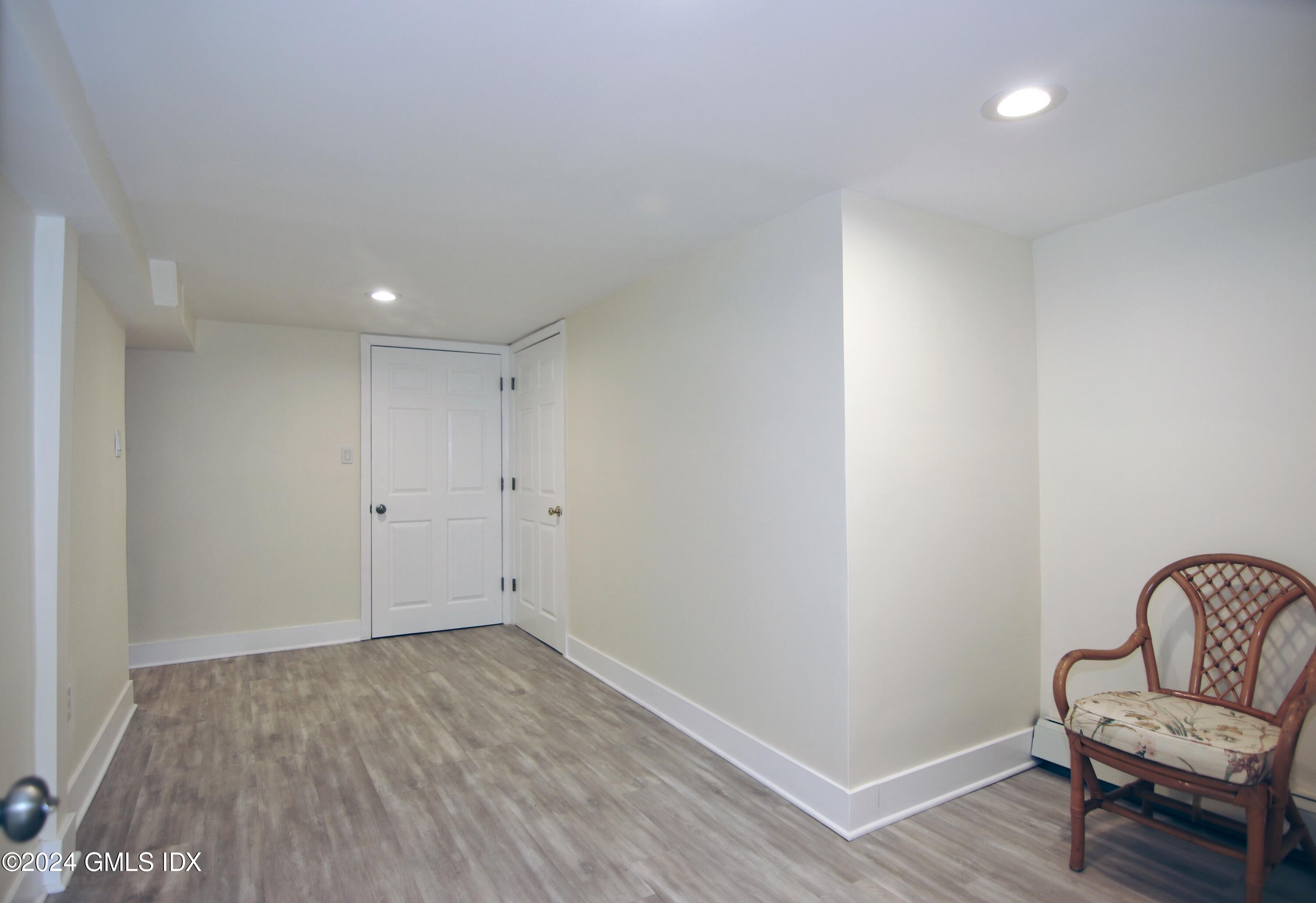 191 Sawmill Road Stamford, CT 06903 - Photo 30 of 40 a view of a hallway with wooden floor and a chair