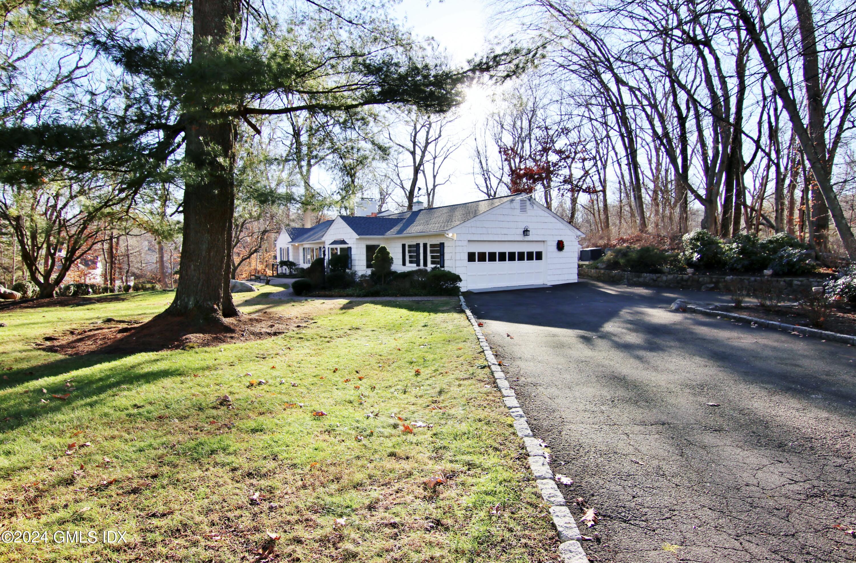 191 Sawmill Road Stamford, CT 06903 - Photo 37 of 40 a sign board in front of a white house
