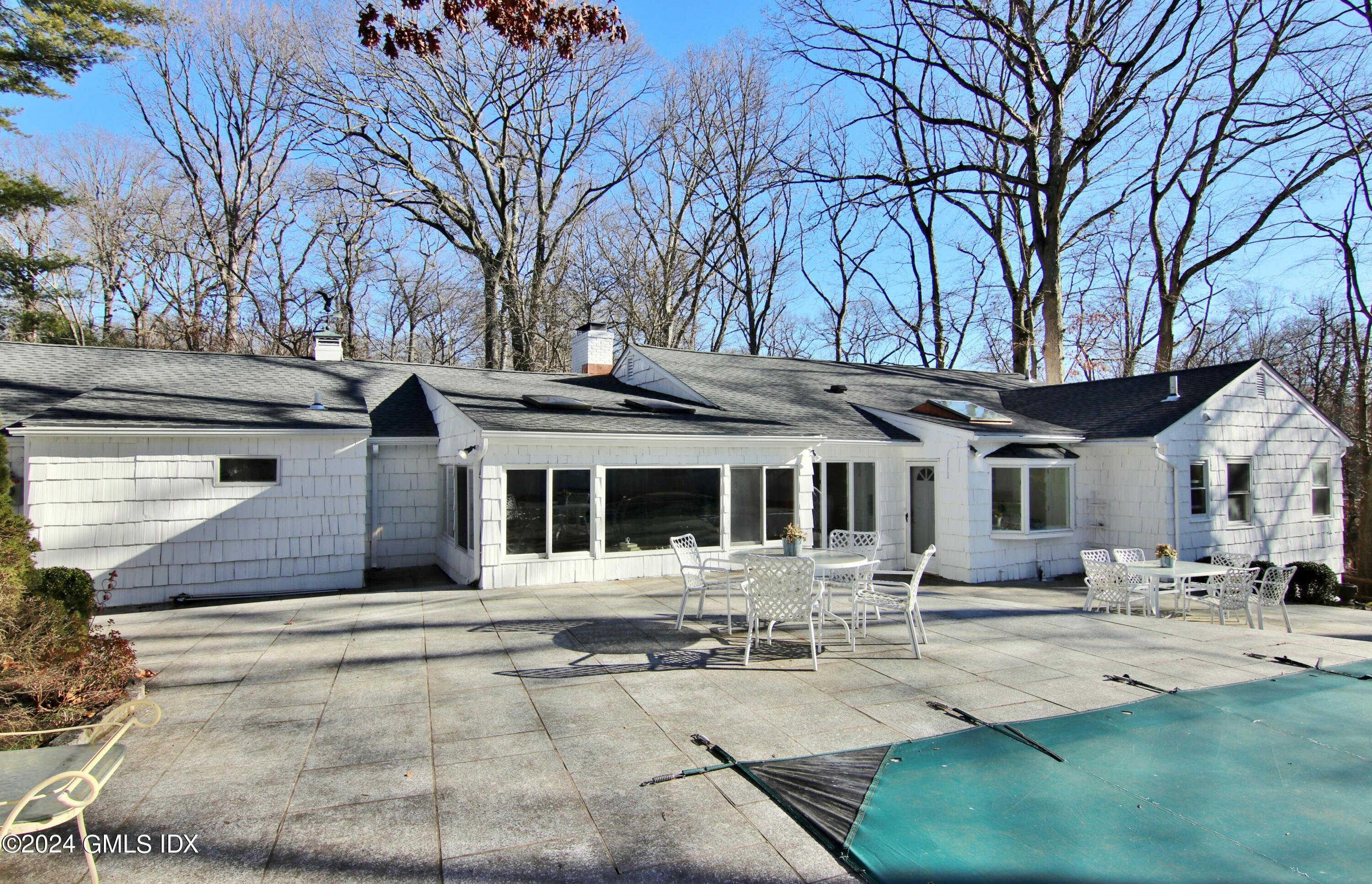191 Sawmill Road Stamford, CT 06903 - Photo 4 of 40 a front view of a house with garden and trees