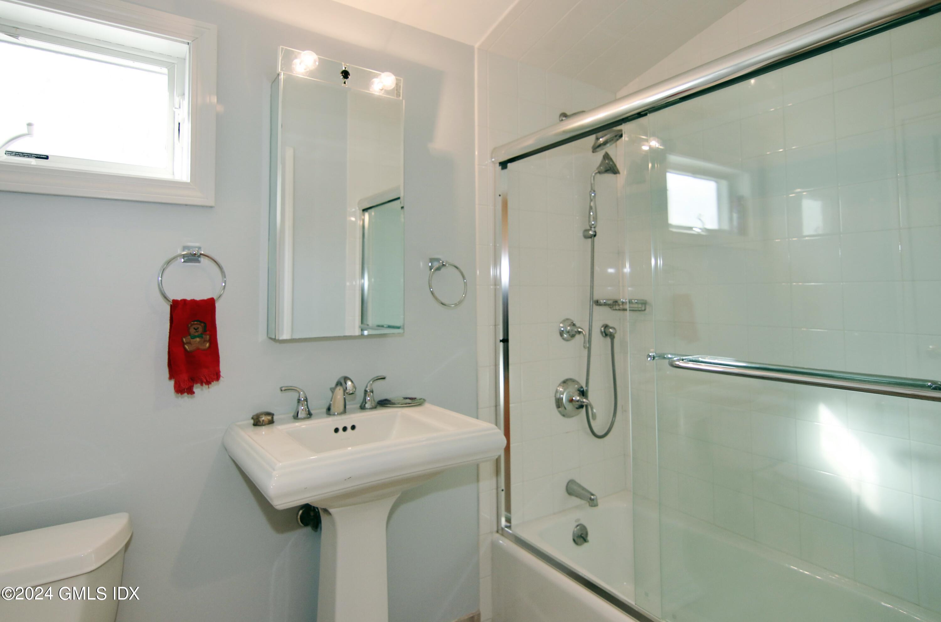 191 Sawmill Road Stamford, CT 06903 - Photo 5 of 40 a bathroom with a shower sink vanity and mirror