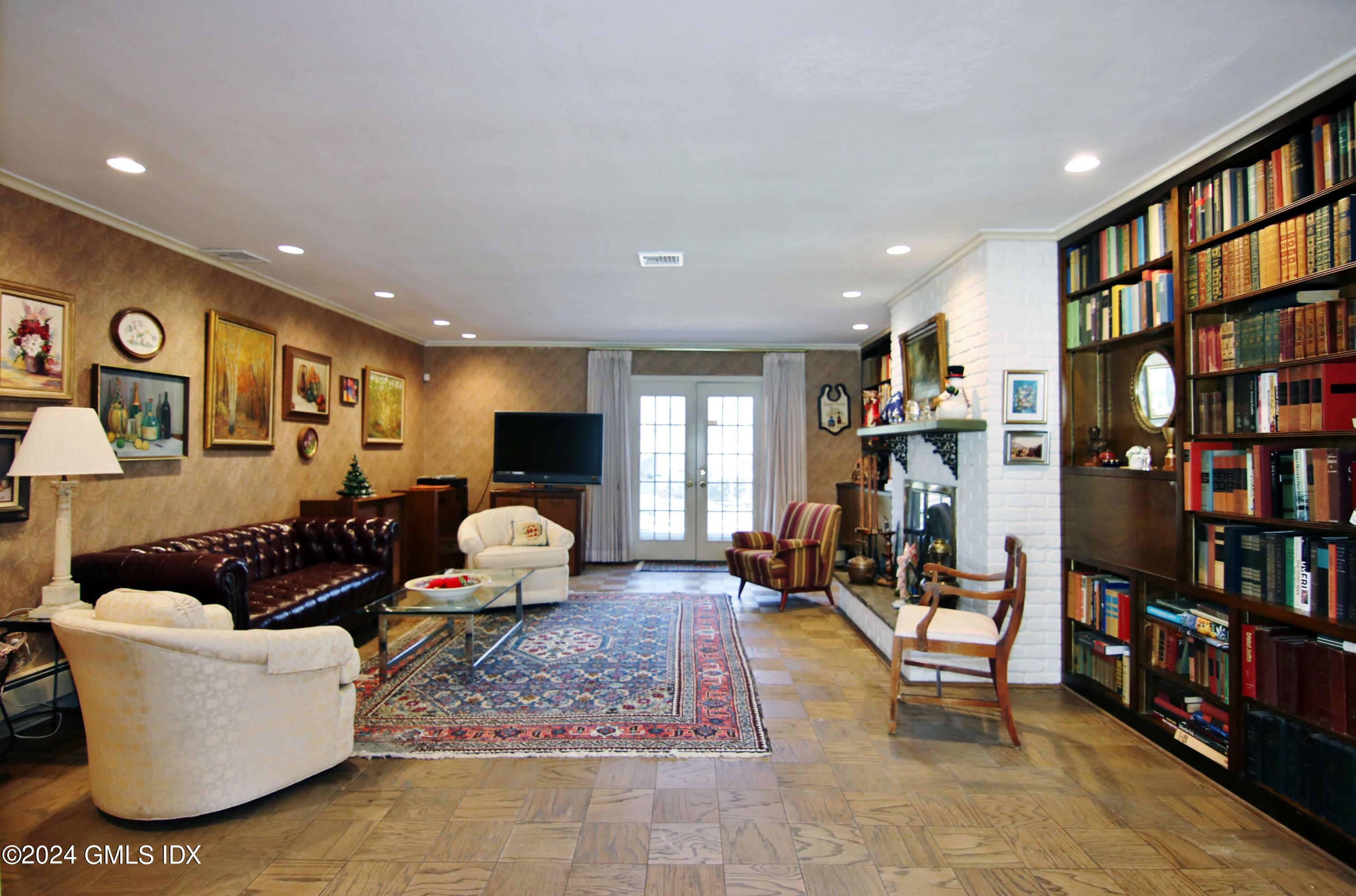 191 Sawmill Road Stamford, CT 06903 - Photo 7 of 40 a living room with furniture a bookshelf and a book shelf