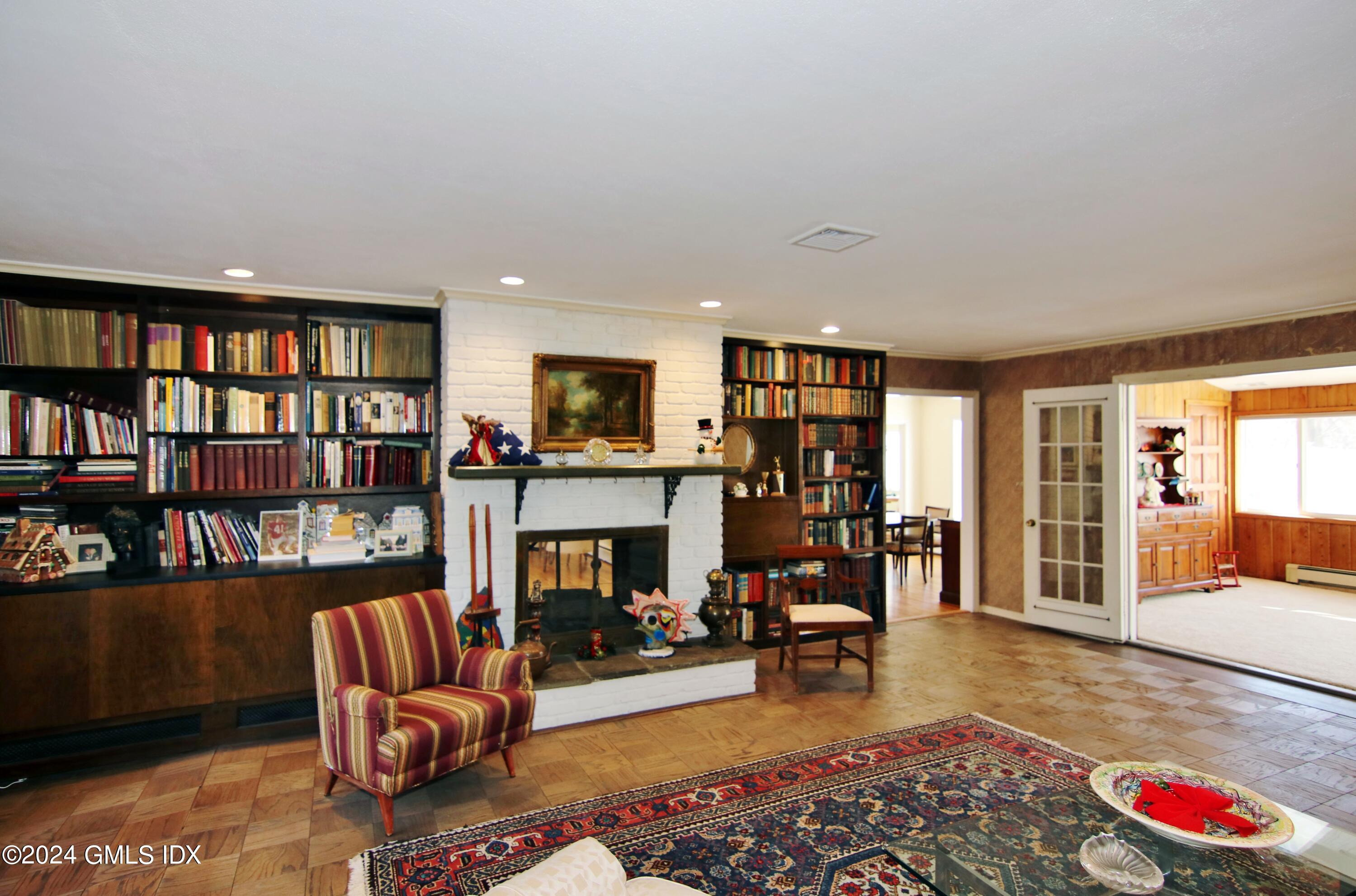191 Sawmill Road Stamford, CT 06903 - Photo 9 of 40 a living room with furniture fireplace and book shelf