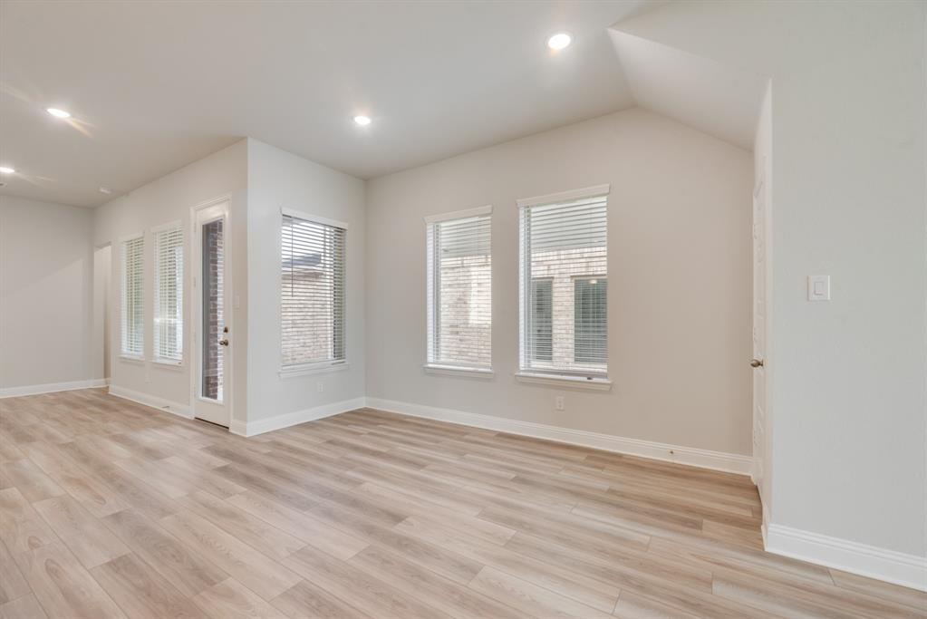 7009 Sunset Boulevard Rowlett, TX 75088 - Photo 13 of 35 a view of an empty room with wooden floor and window