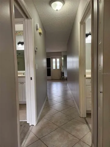 an empty room with wooden floor and mirror